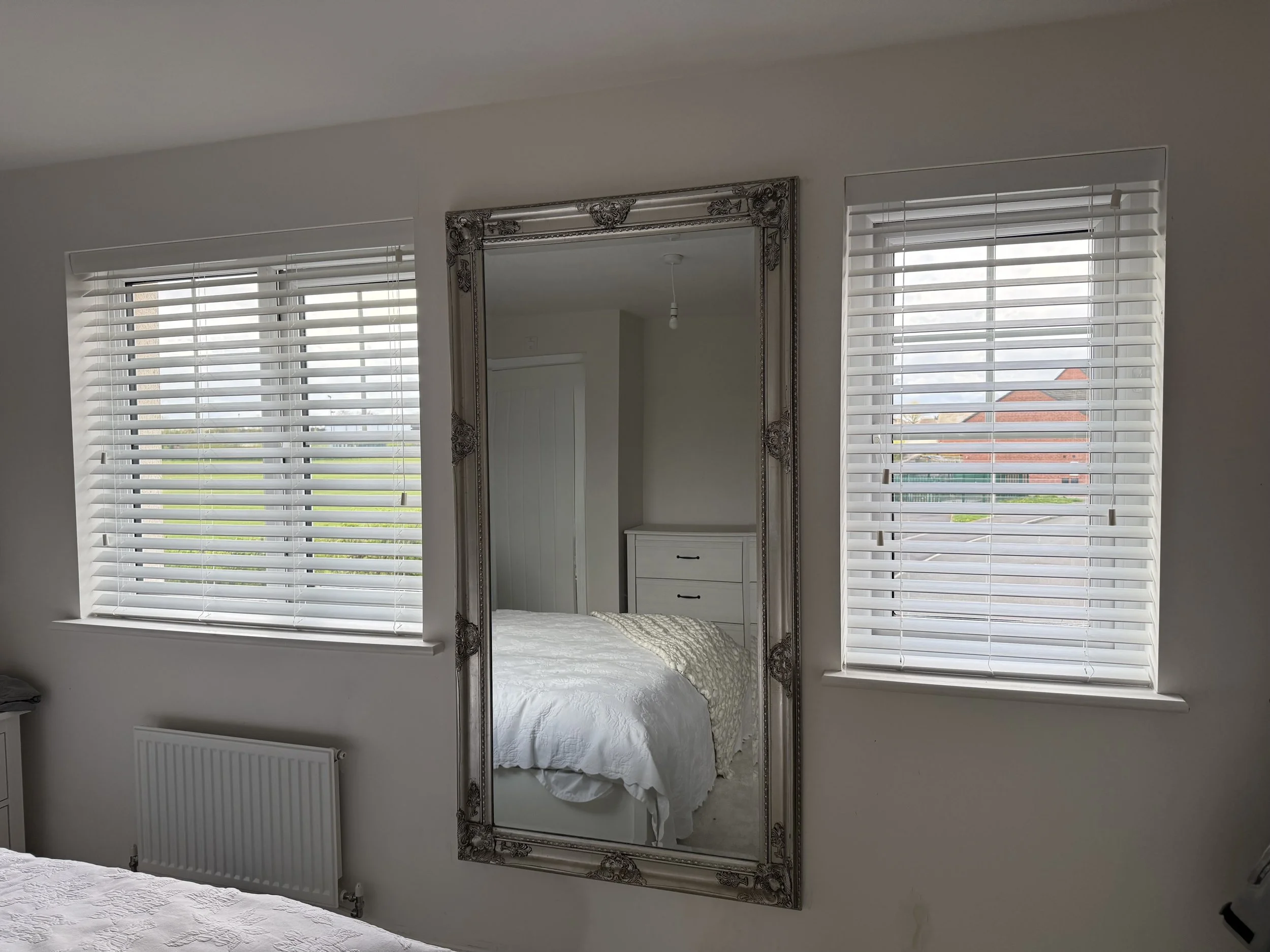 Faux wood blinds fitted in bedroom in Golborne