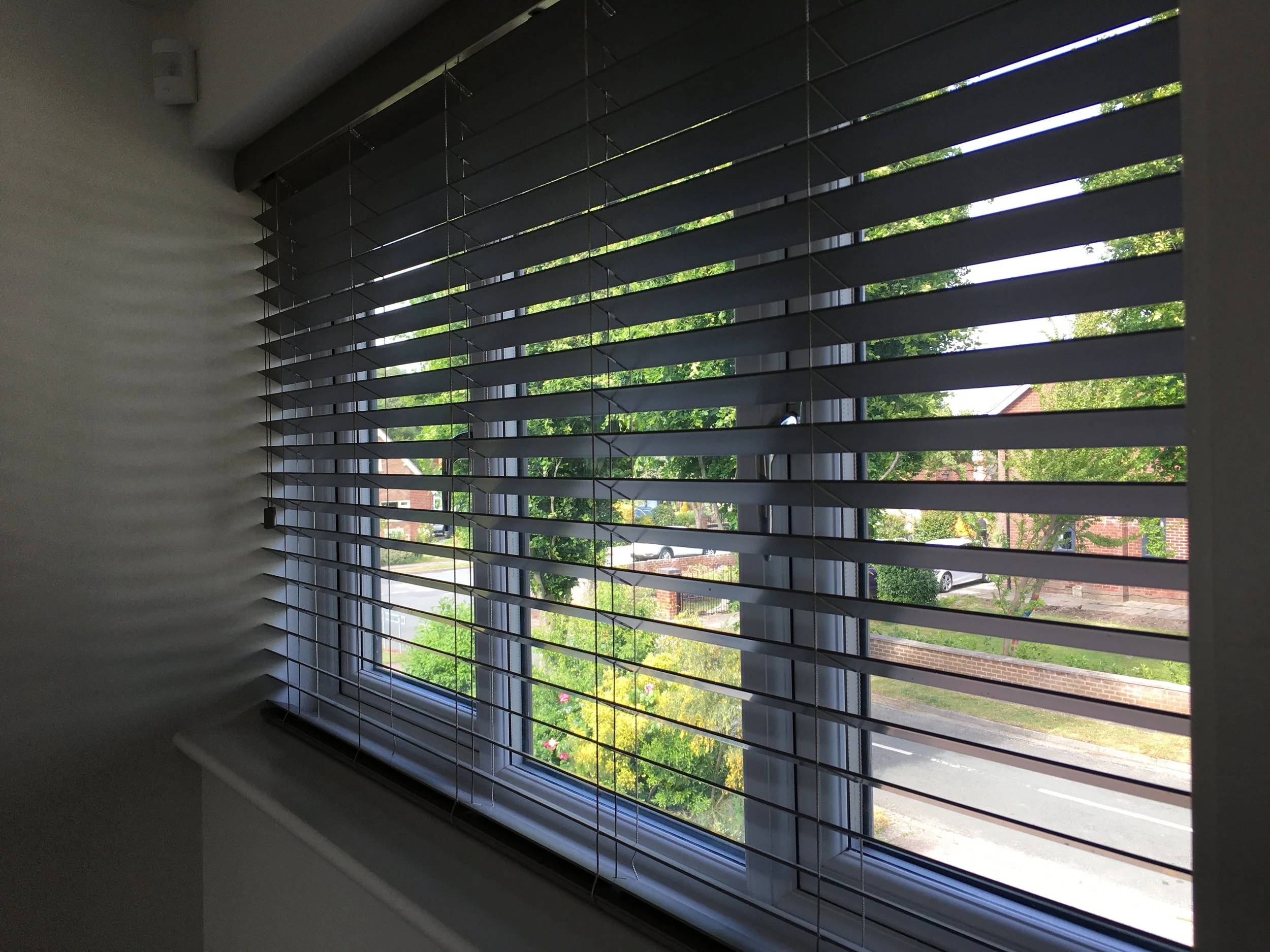 Anthracite Faux wood blinds fitted to a window in Lowton