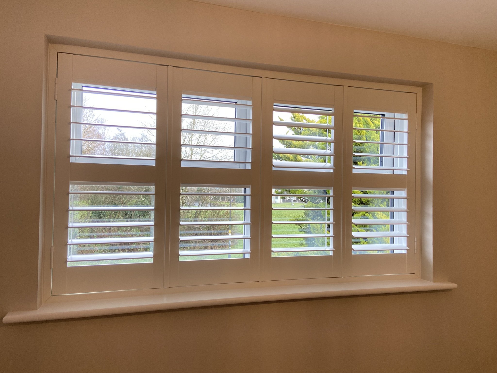 PVC shutters with midrail fitted in Astley