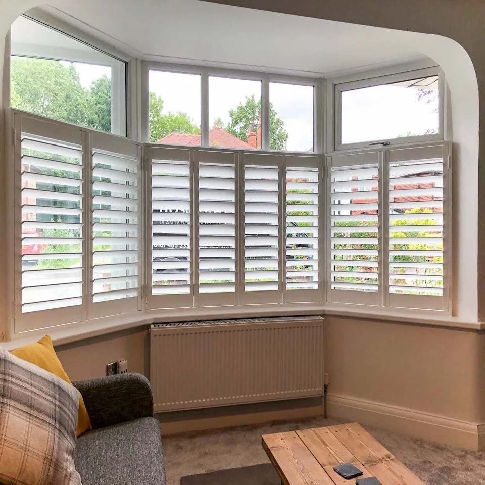 Cafe Style Shutters fitted to a Lounge bay window in Sale