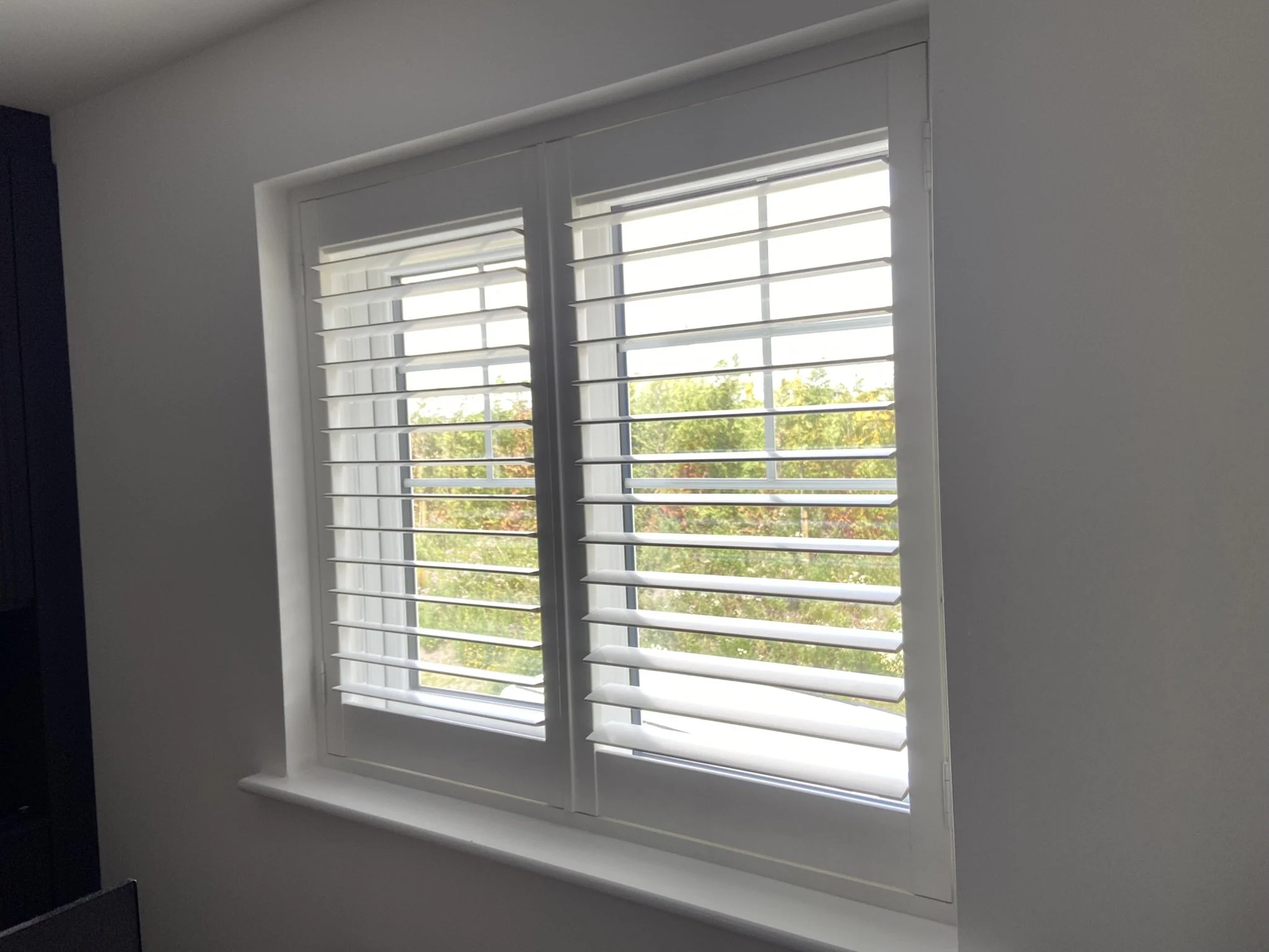 Plantation shutters fitted to a window in Leigh