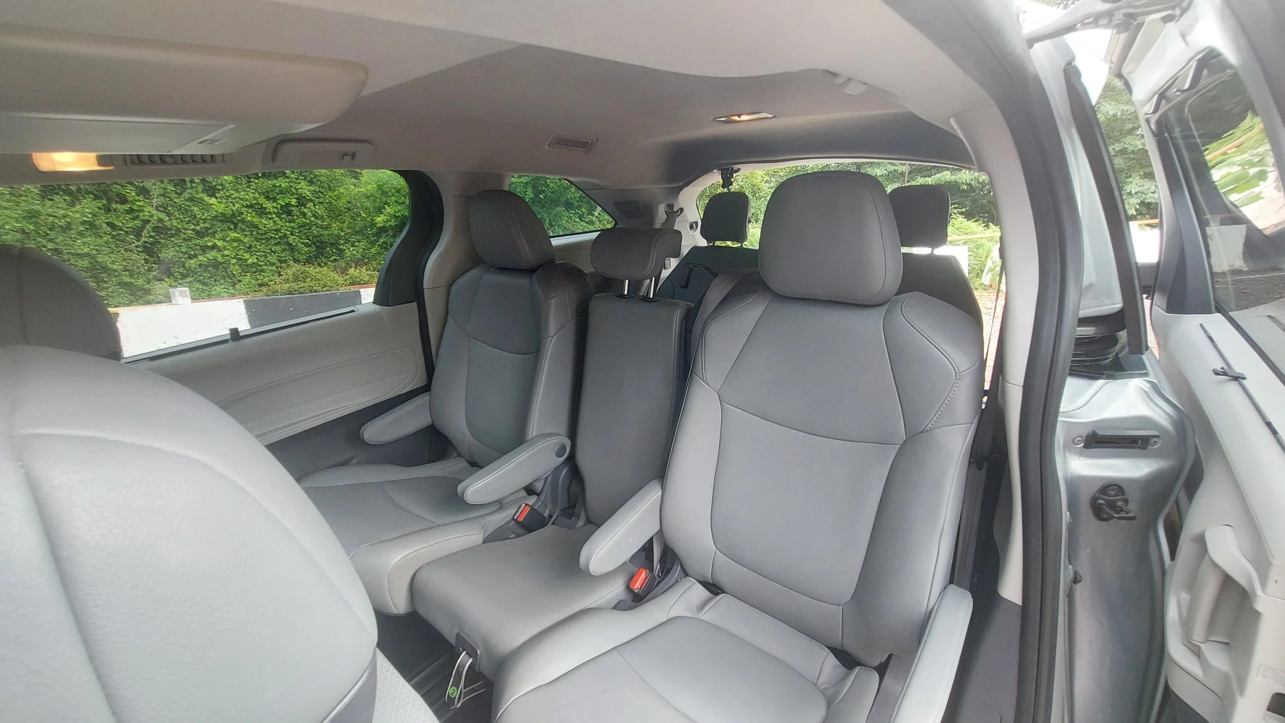 Premium travel comfort in Georgia: Climate-controlled, spacious leather seating inside our 2021 Toyota Sienna Hybrid.