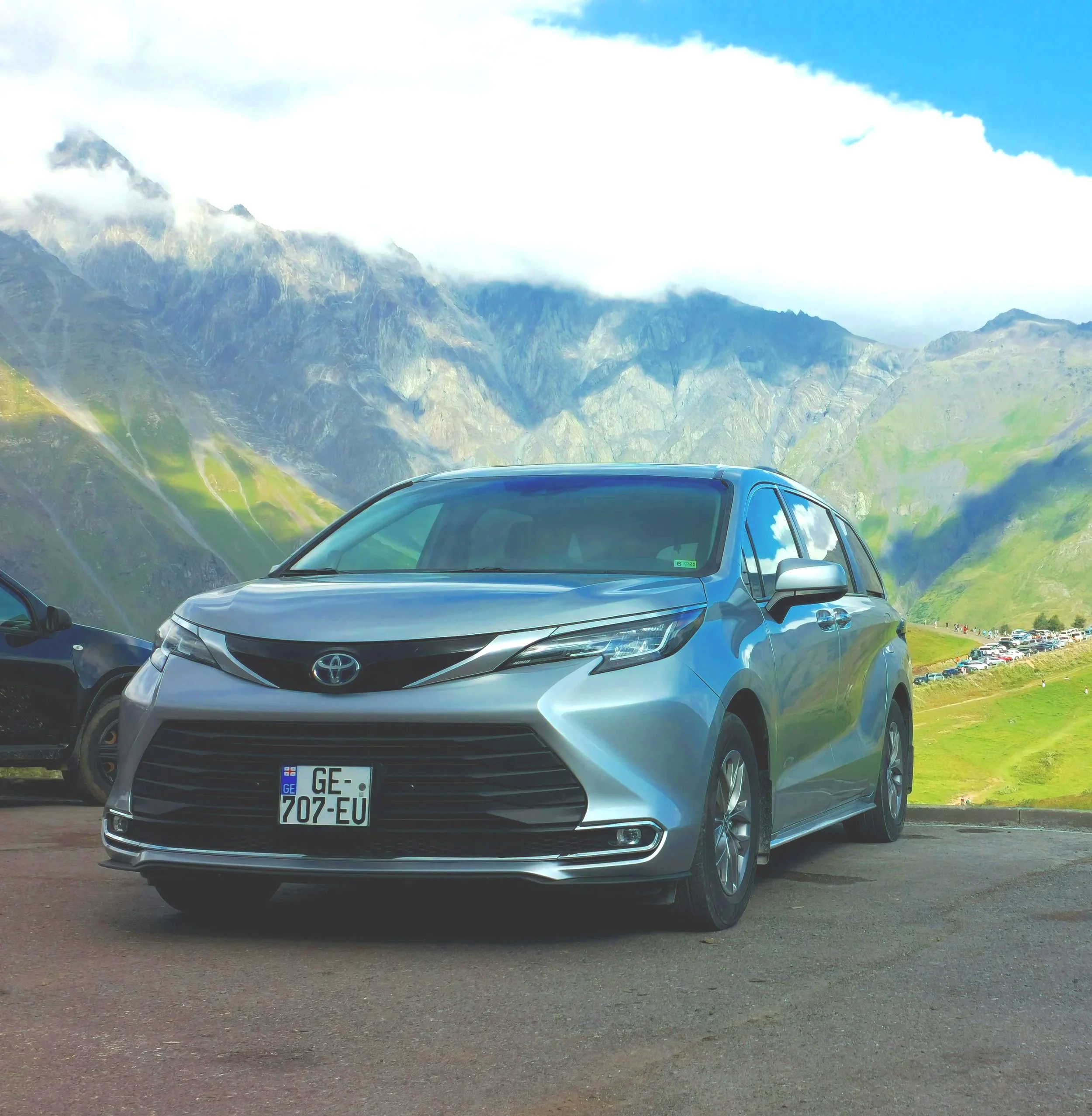 Private guided tour in Georgia: Our premium 2021 Toyota Sienna Hybrid overlooking the breathtaking Caucasus mountains.