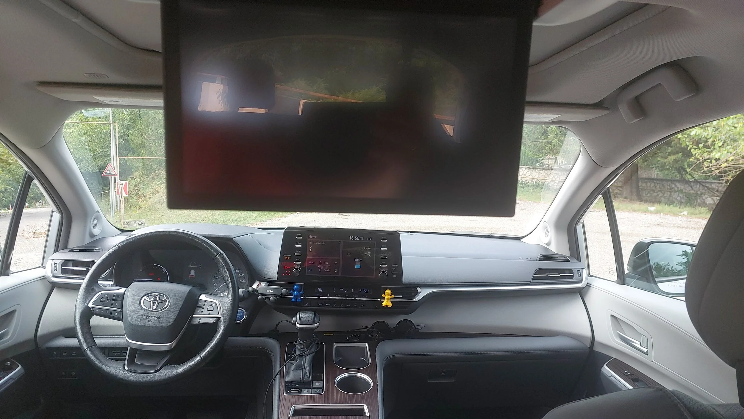 Spacious interior of our 2021 Toyota Sienna Hybrid featuring a digital display and entertainment screen for premium travel in Georgia.