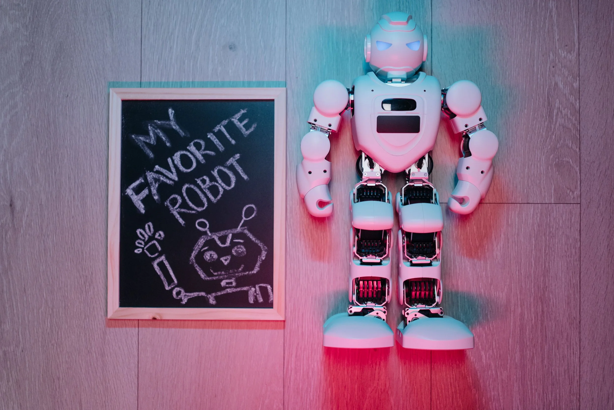robot and chalkboard beside with phrase, my favorite robot representing the rise of artificial intelligence and its use