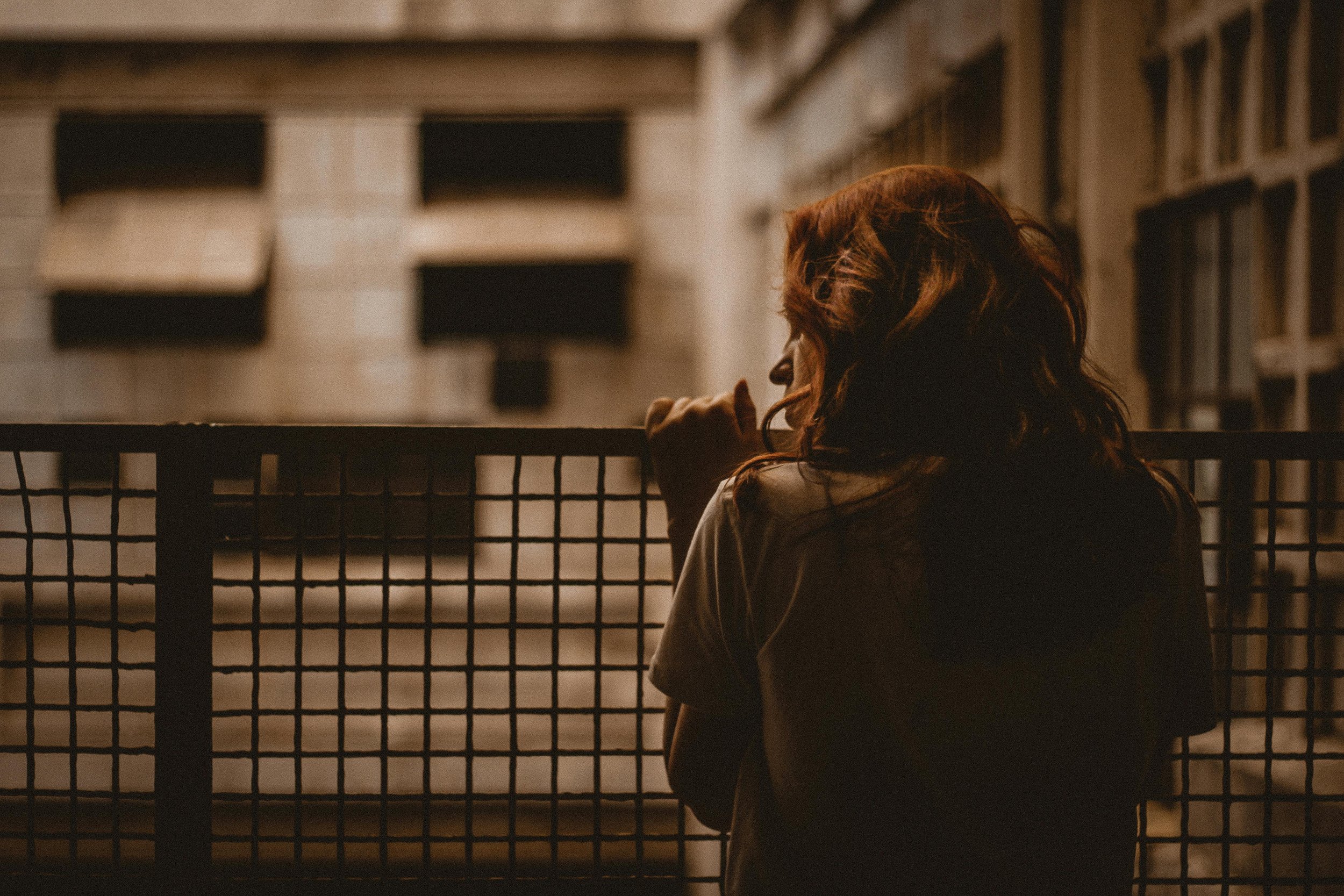 woman standing having feelings of anxiety and depression worrying about overthinking - feeling attached