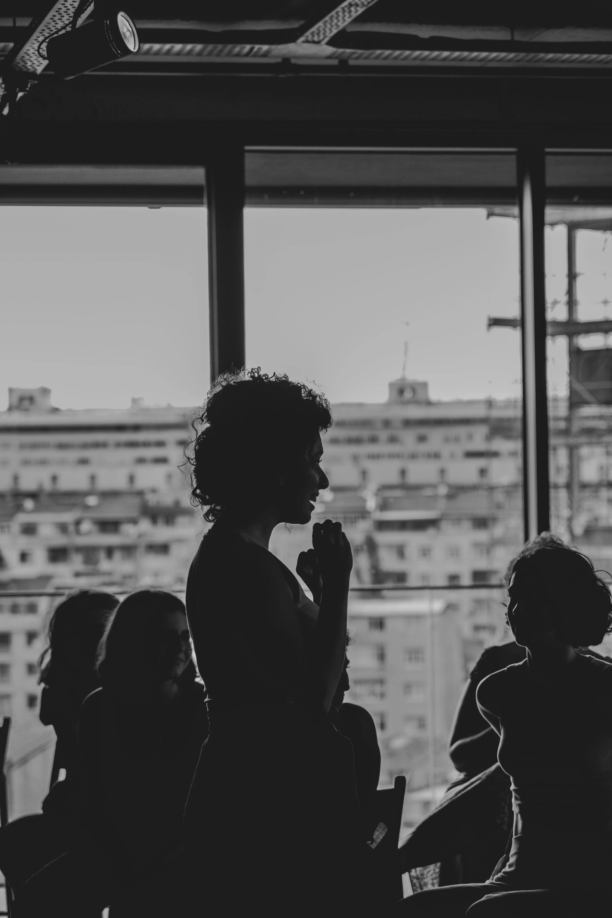 woman standing in front of group of people in social setting showing people pleasing tendencies helping describe further shadow concept elaborated on my becoming on point
