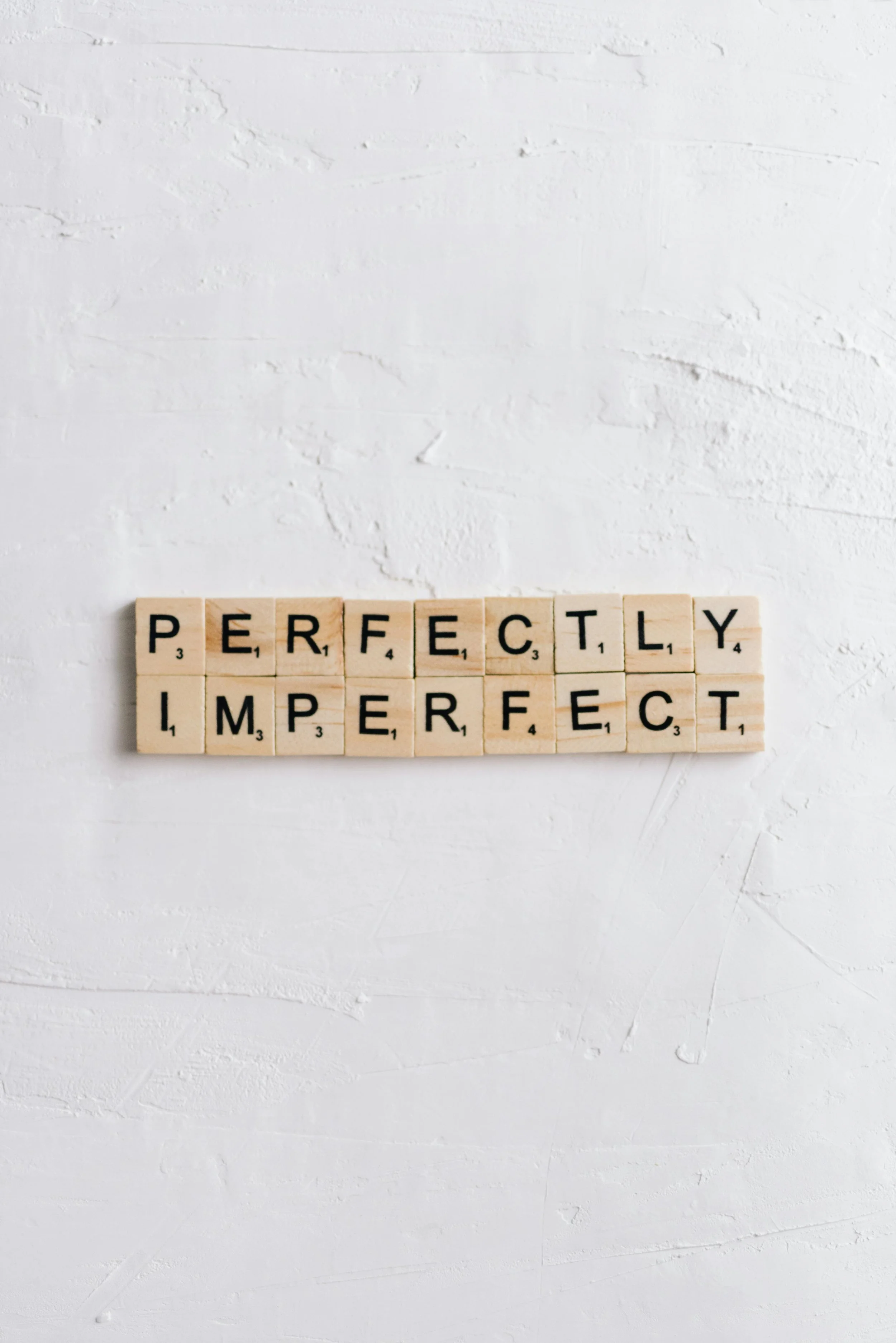 perfection in imperfection letter blocks representing persona concept regarding shadow of shame from jungian perspective