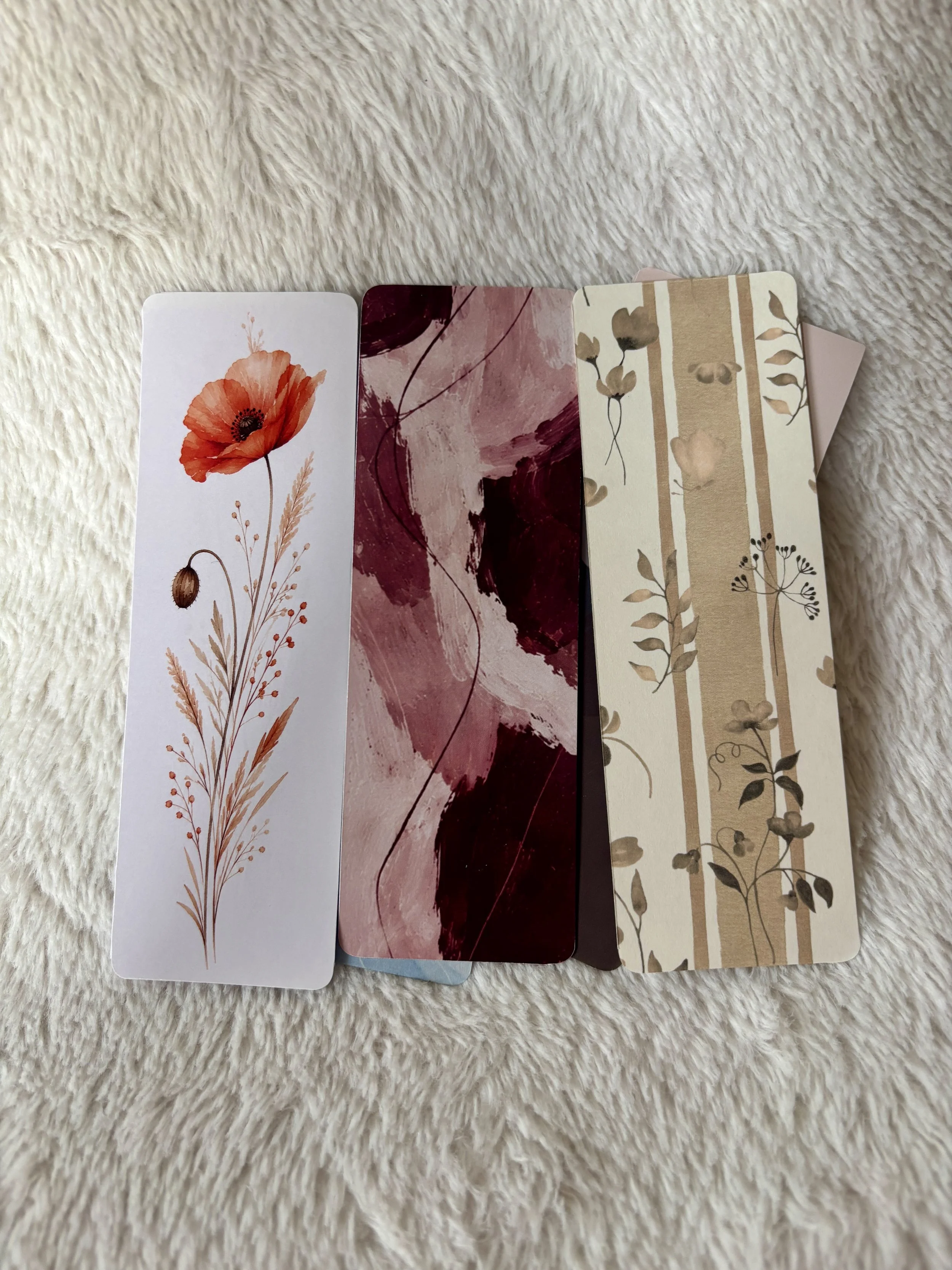 Complete collection of six The Femme Letter bookmarks featuring burgundy abstract, green quote, beige botanical, pink mountain, red poppy and blue quote designs.