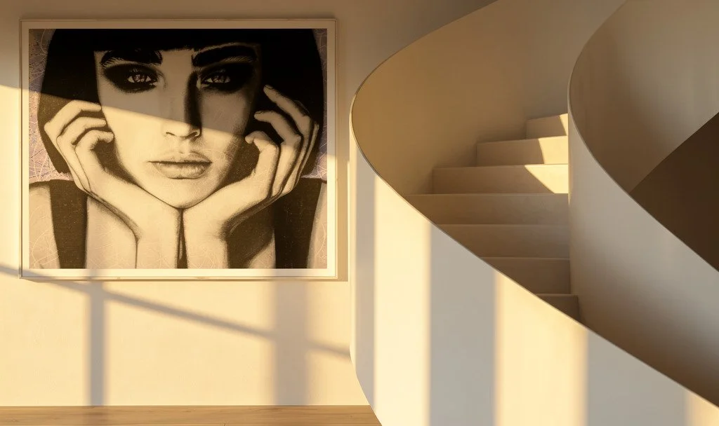 A large black and white portrait of a woman with dark eyes, framed and hanging on a wall in a modern interior.