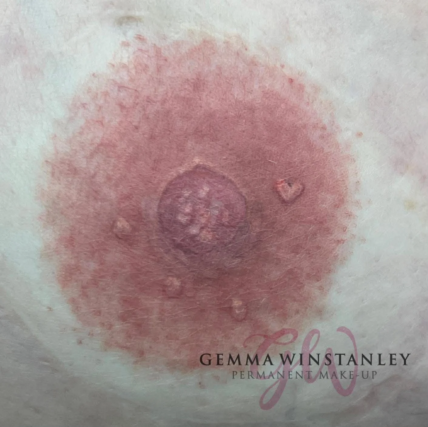 Close-up of a cosmetic tattooed eyebrow with the text 'GEMMA WINSTANLEY PERMANENT MAKE-UP' overlayed.