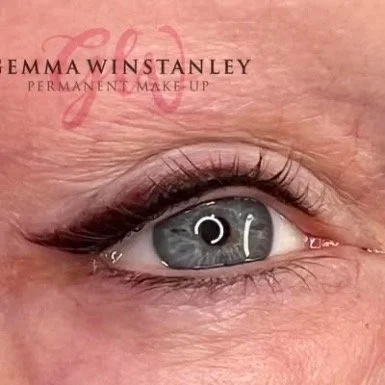 Close-up of a person's eye with makeup and the text 'Emma Winstanley Permanent Make-up' above it.