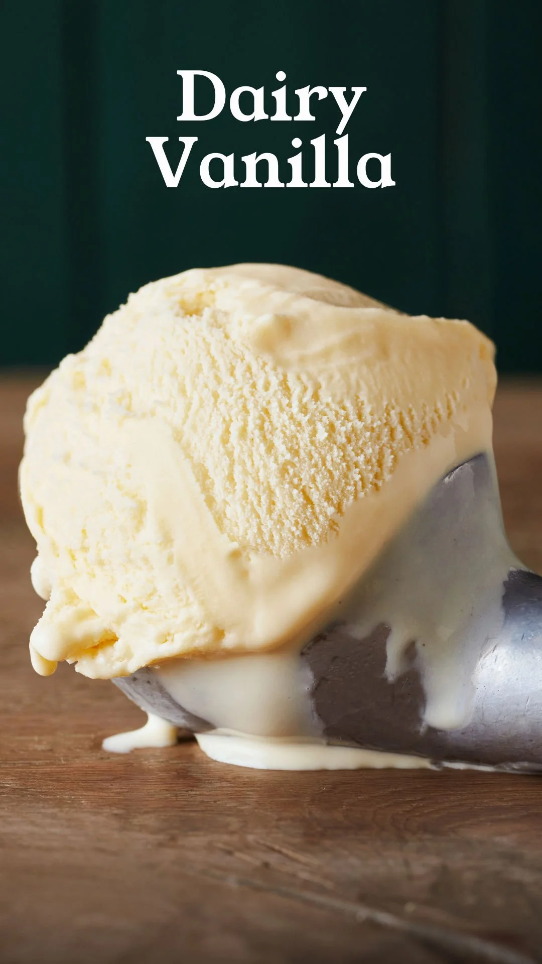 Scoops of vanilla ice cream on a wooden surface with melting around the base.