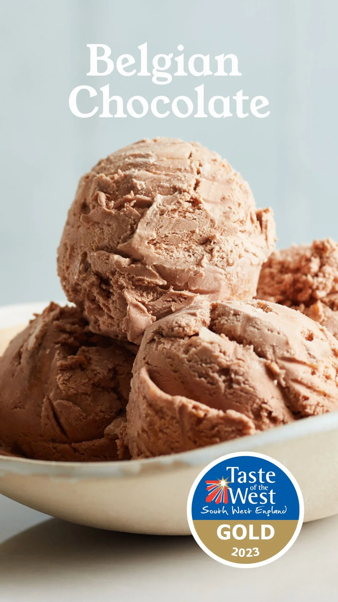 Close-up of three scoops of Belgian chocolate ice cream in a white bowl with a Taste of the West South West England Gold 2023 badge.