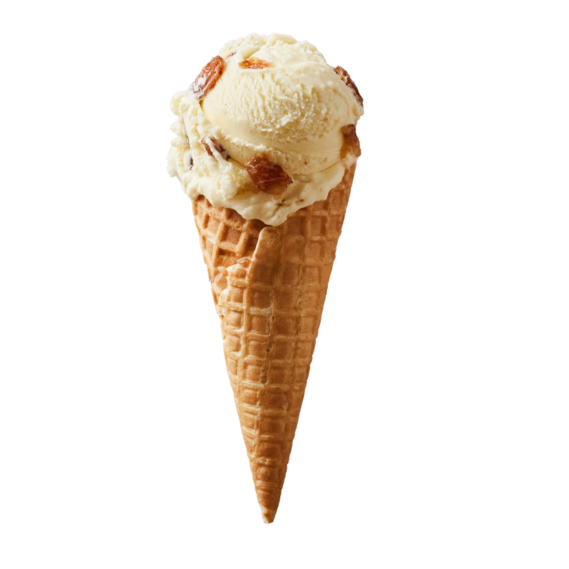 A scoop of vanilla ice cream with caramel and nut pieces in a waffle cone.