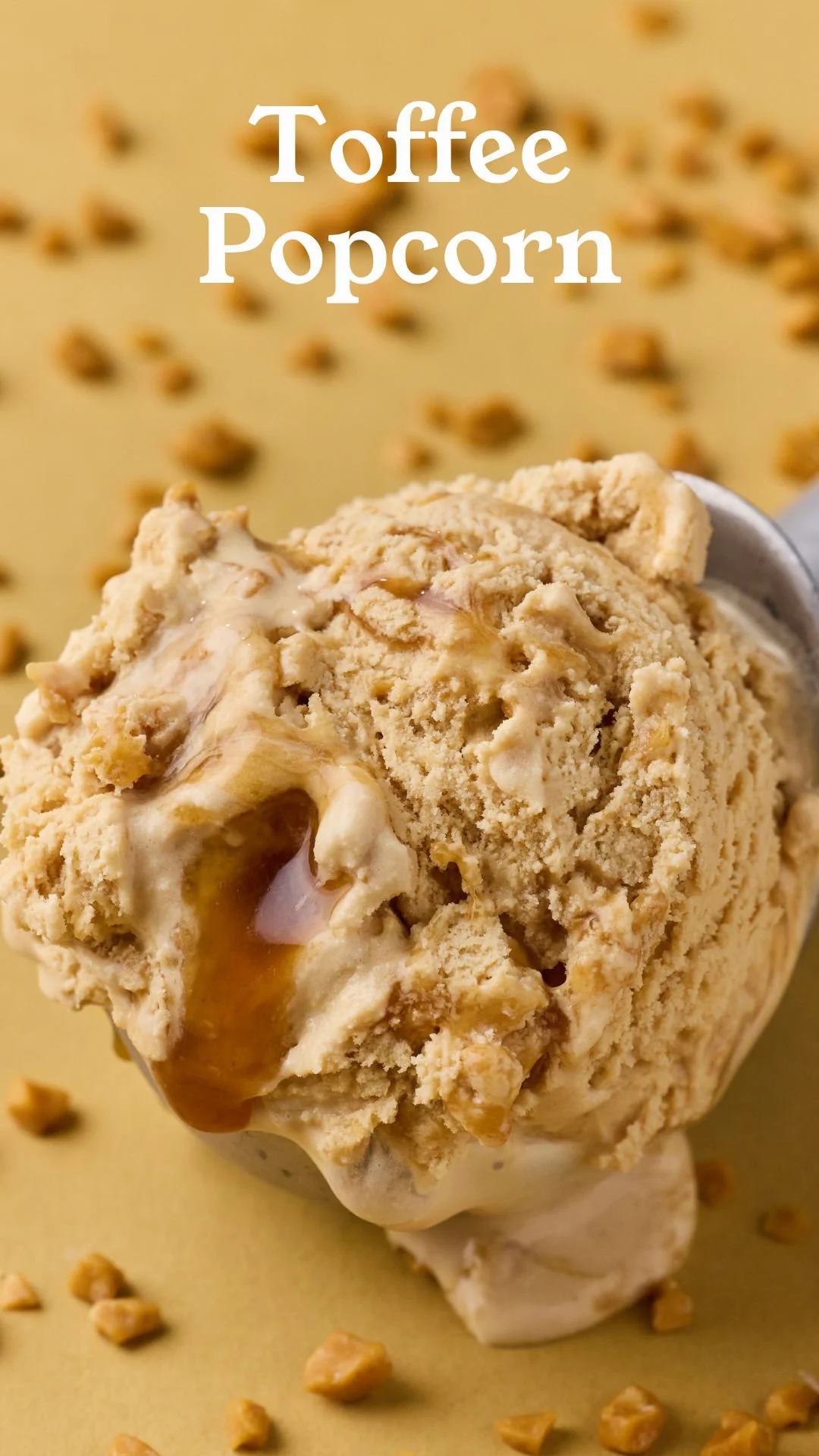 Close-up of a scoop of toffee popcorn ice cream with caramel swirls, with scattered toffee pieces on a yellow background.