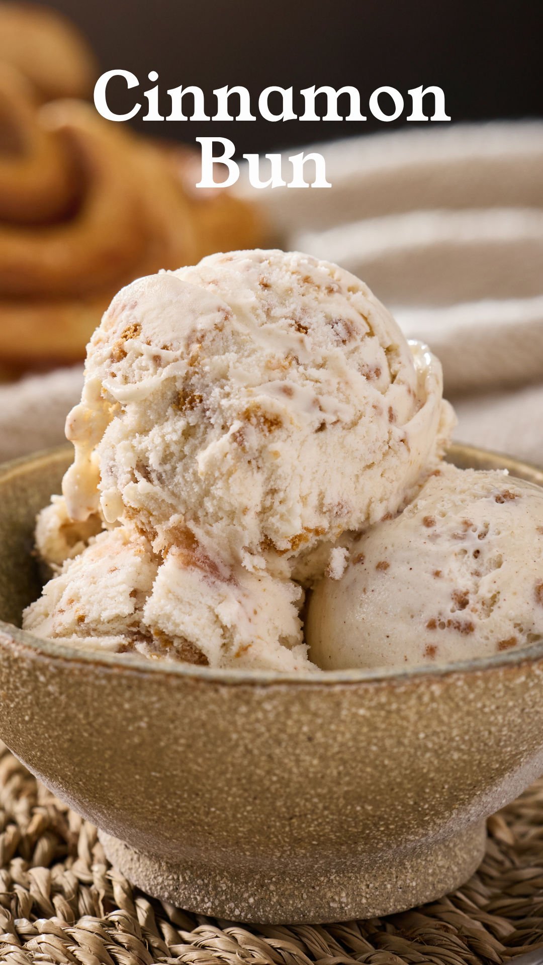 A bowl of vanilla ice cream with cinnamon pieces, labeled 'Cinnamon Bun'.
