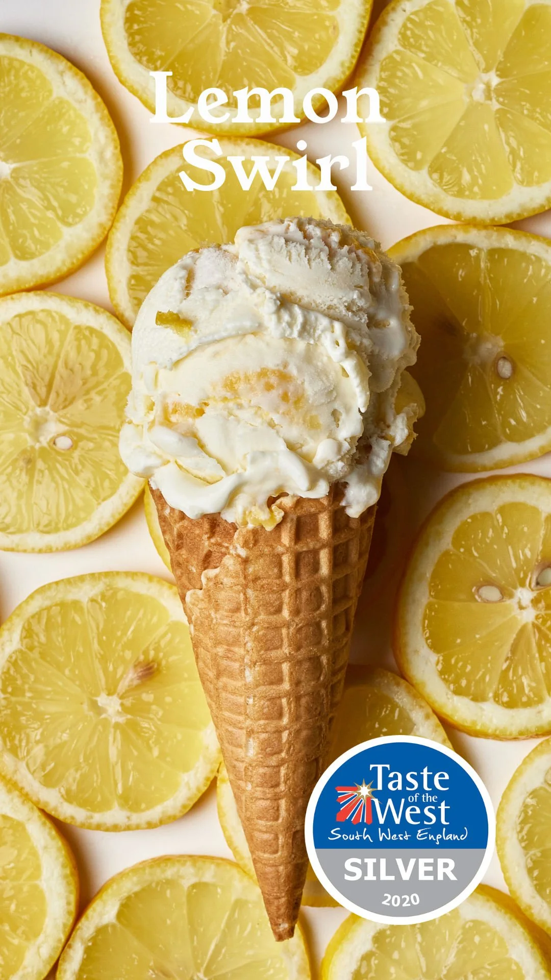 Lemon ice cream in a waffle cone surrounded by lemon slices with a "Taste of the West" South West England Silver 2020 award badge.