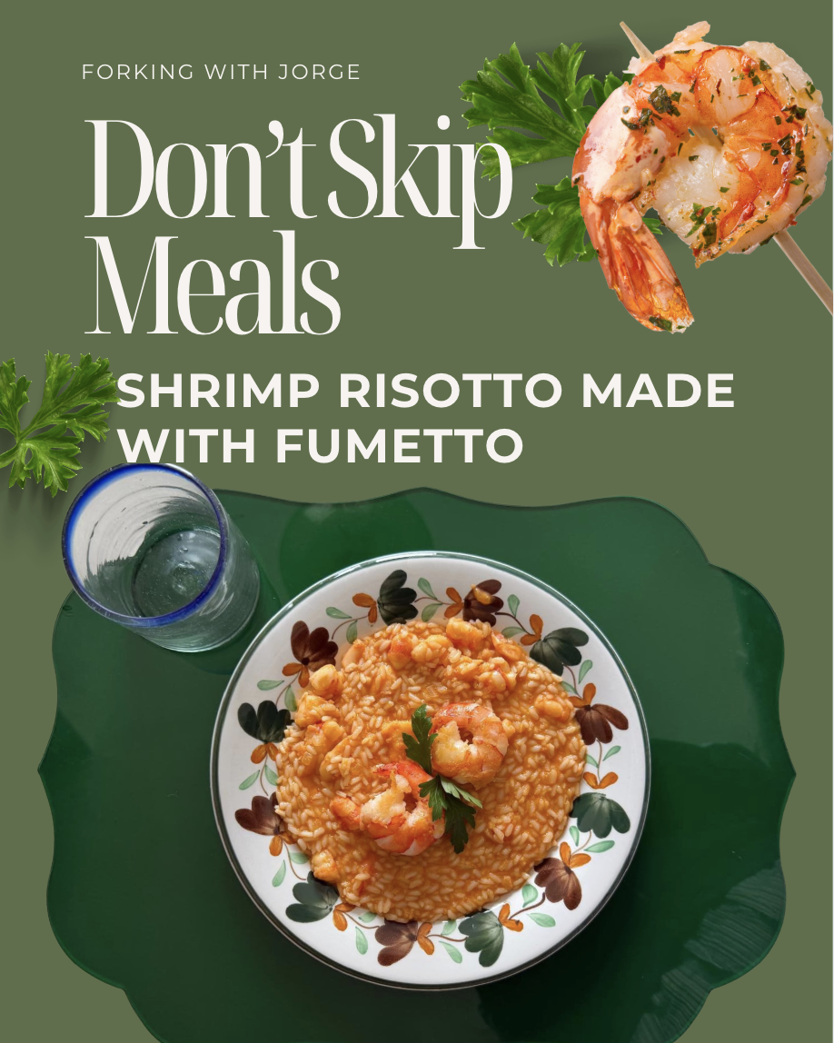 Cover image of a food blog or recipe book titled 'Forking with Jorge: Don't Skip Meals.' The dish is shrimp risotto with fumetto, served on a decorative plate with black and orange flower patterns, garnished with parsley, and placed on a dark green surface. A glass of water and a prawn skewer with shrimp and herbs are also visible.