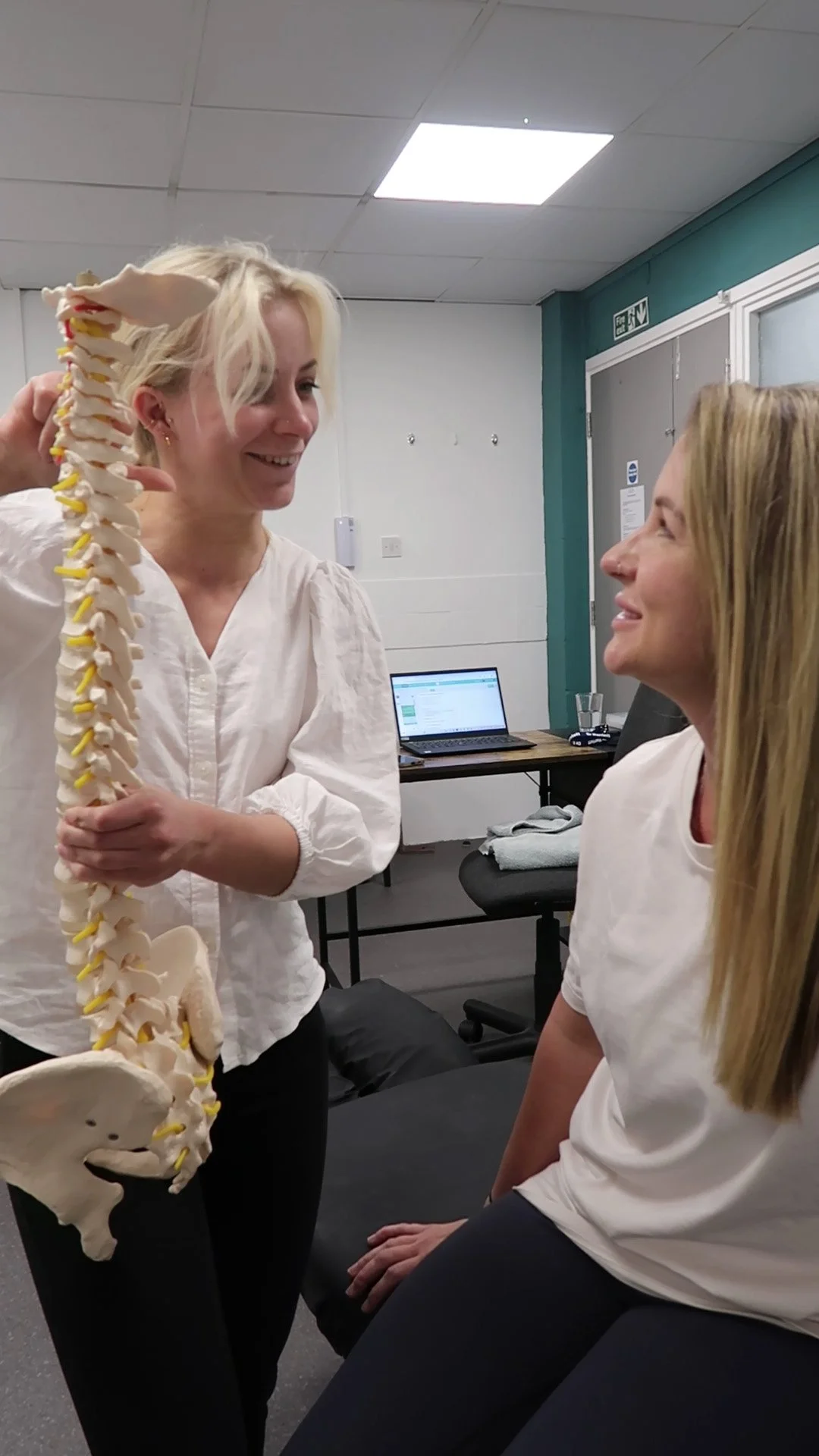 Chiropractic Doctor showing a patient the anatomy of the spine