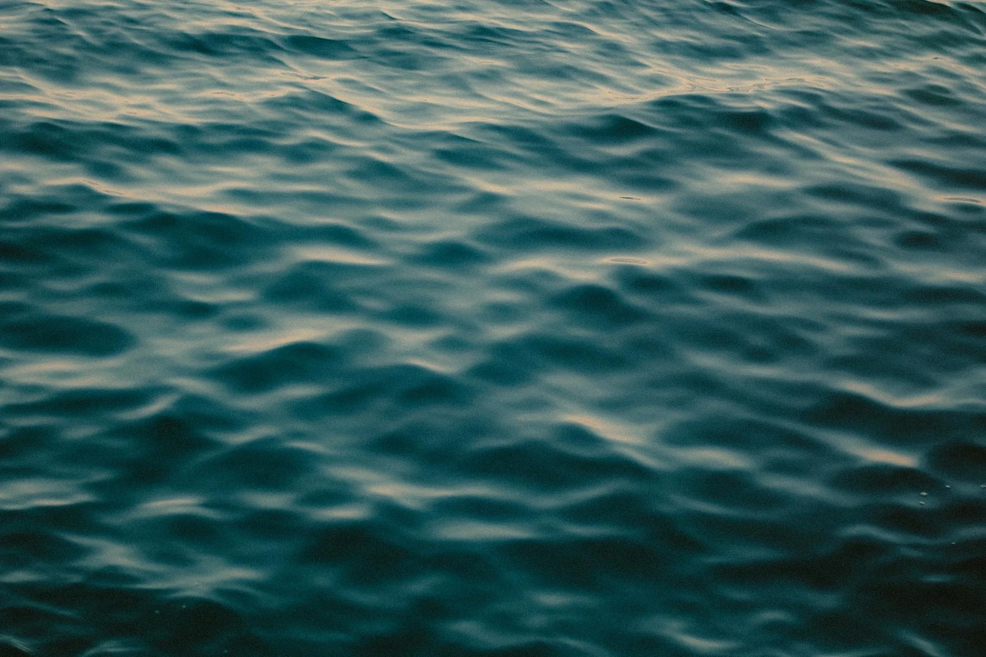 Calm ocean water with gentle waves and reflections.