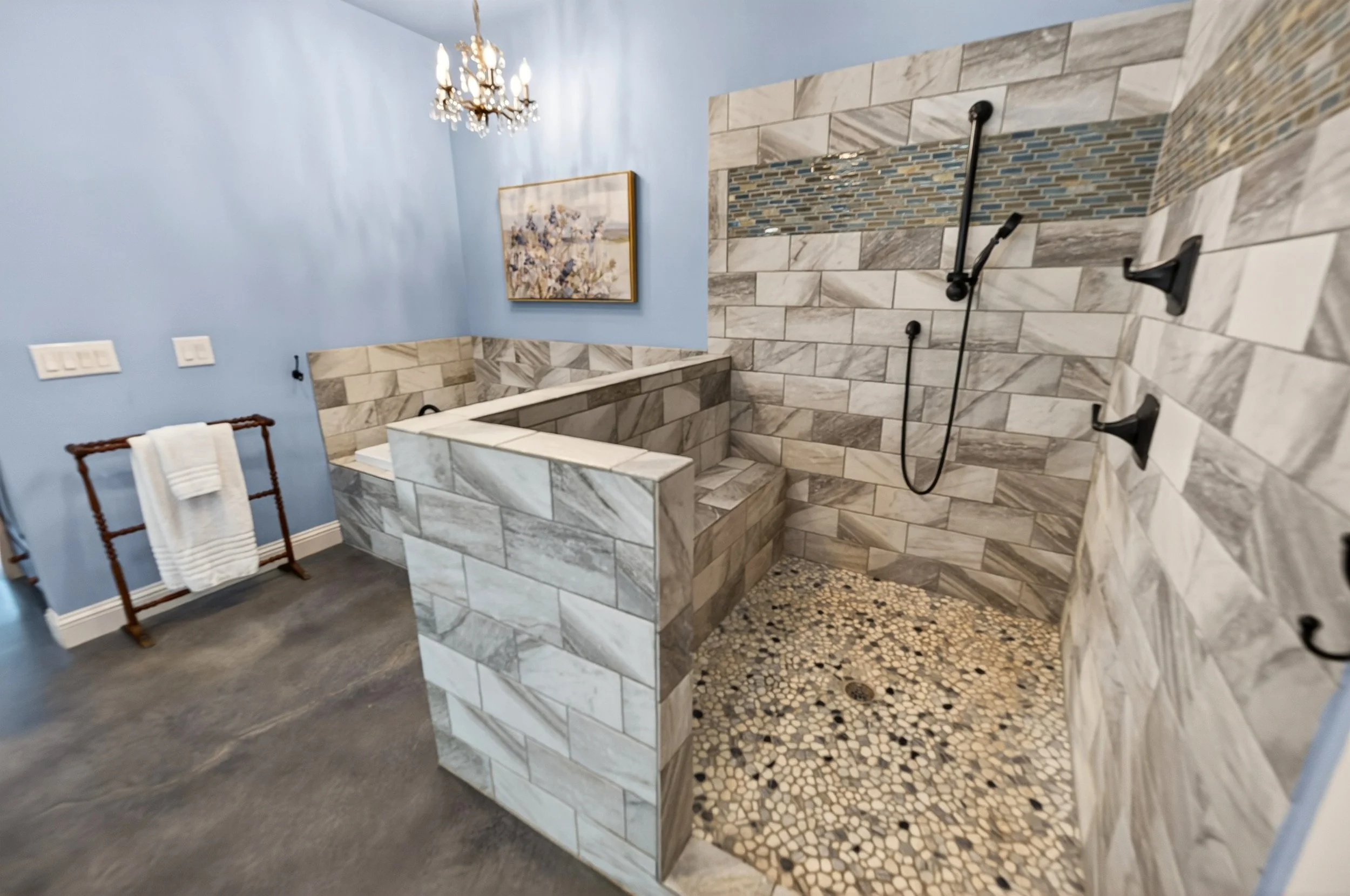 Walk-in shower with separate handheld.
