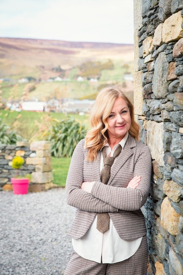 Woman outdoors with healthy, styled hair using Glas Hair Care – sustainable, vegan haircare inspired by the Irish landscape.