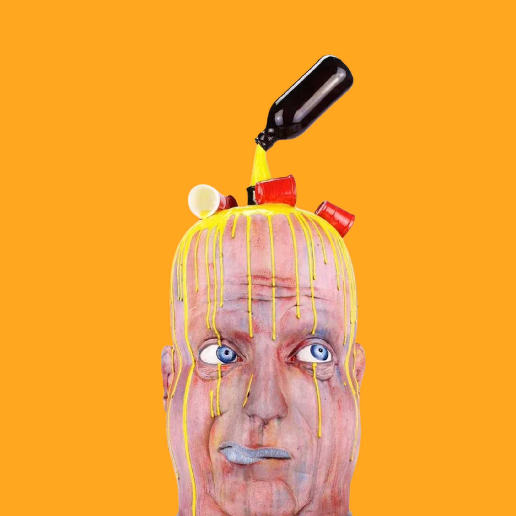 A surreal mixed-media art piece featuring a human face with blue eyes, painted skin, and exaggerated features. The head appears to be melting or dripping yellow paint, with objects such as a plastic bottle, red cups, and a candy-like object embedded or placed on top of the head. The background is solid orange.