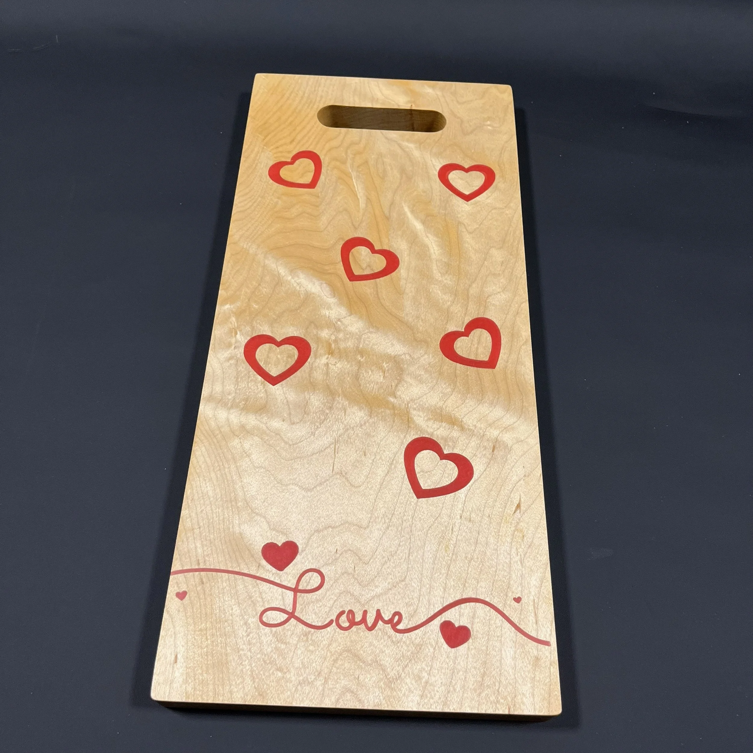 Red hearts on hard maple.