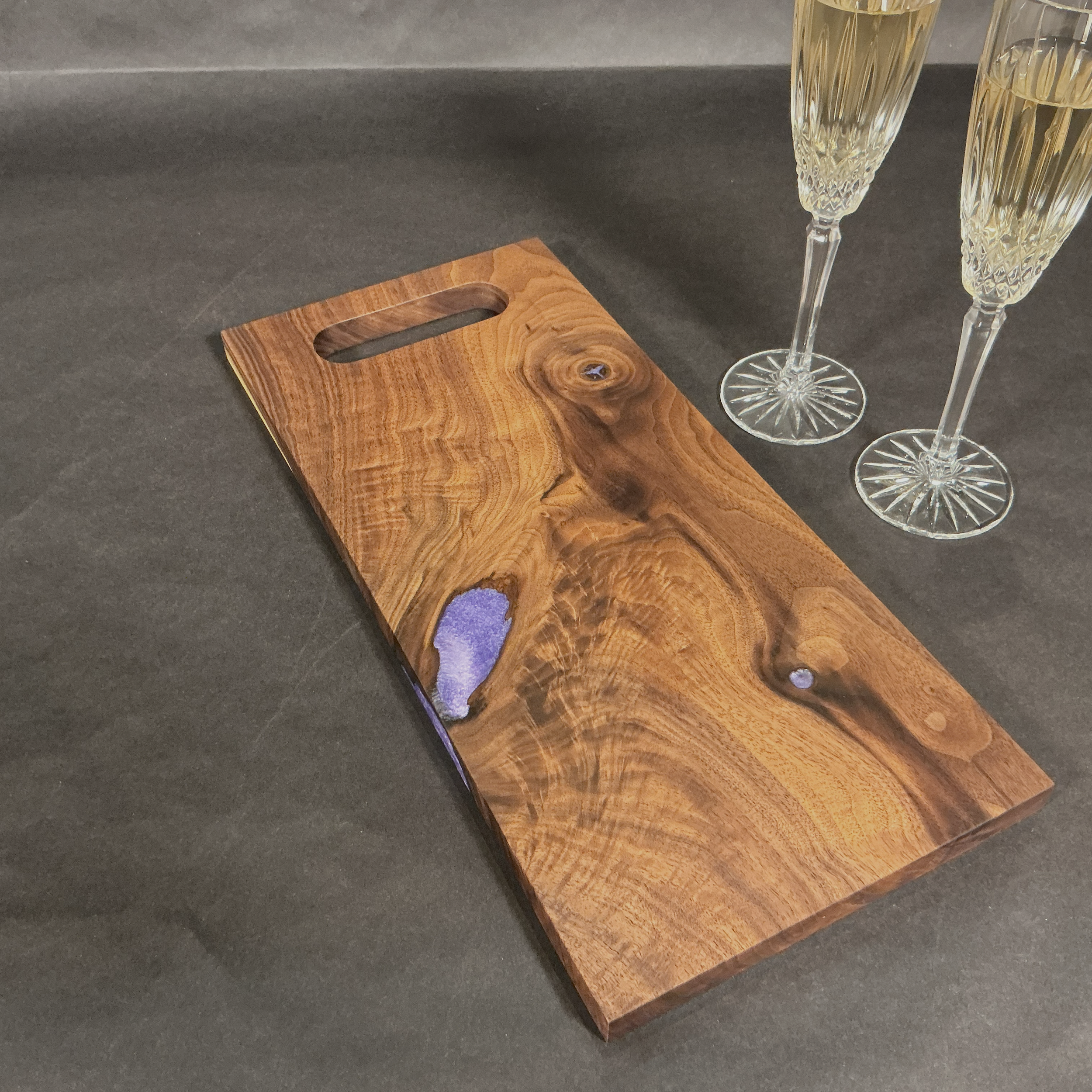 Rich walnut with burl and purple epoxy.