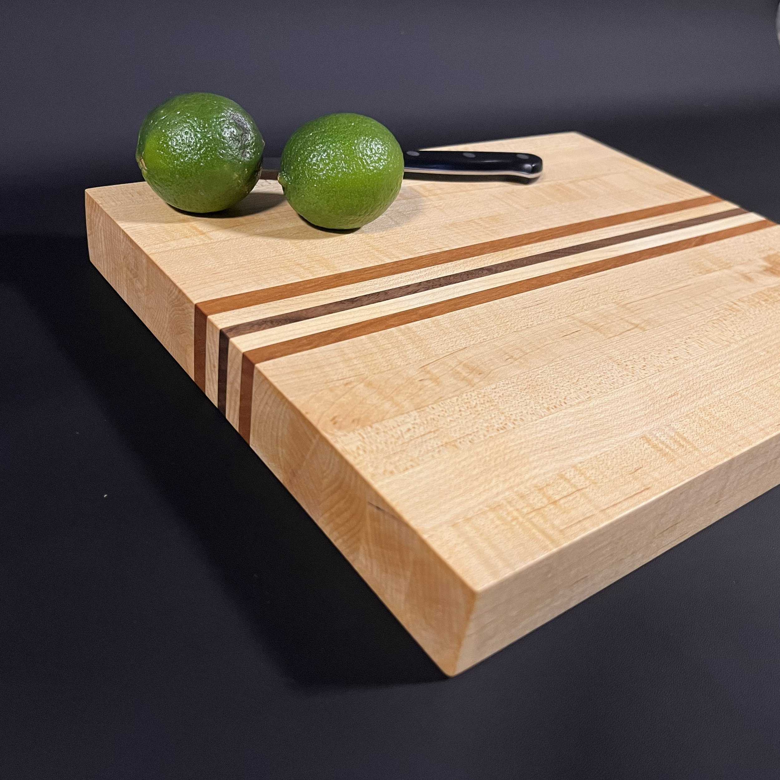 The Ozarks Maple cutting board made of hard maple with accents of cherry and walnut.