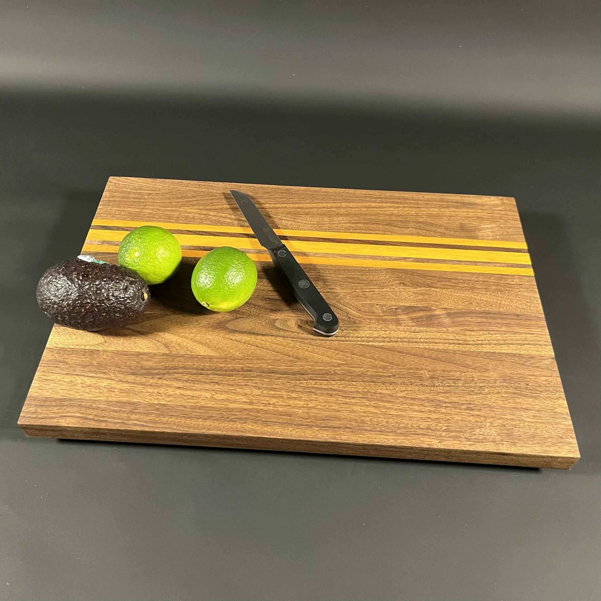 The Osage Nation cutting board made of walnut with Osage orange accents.