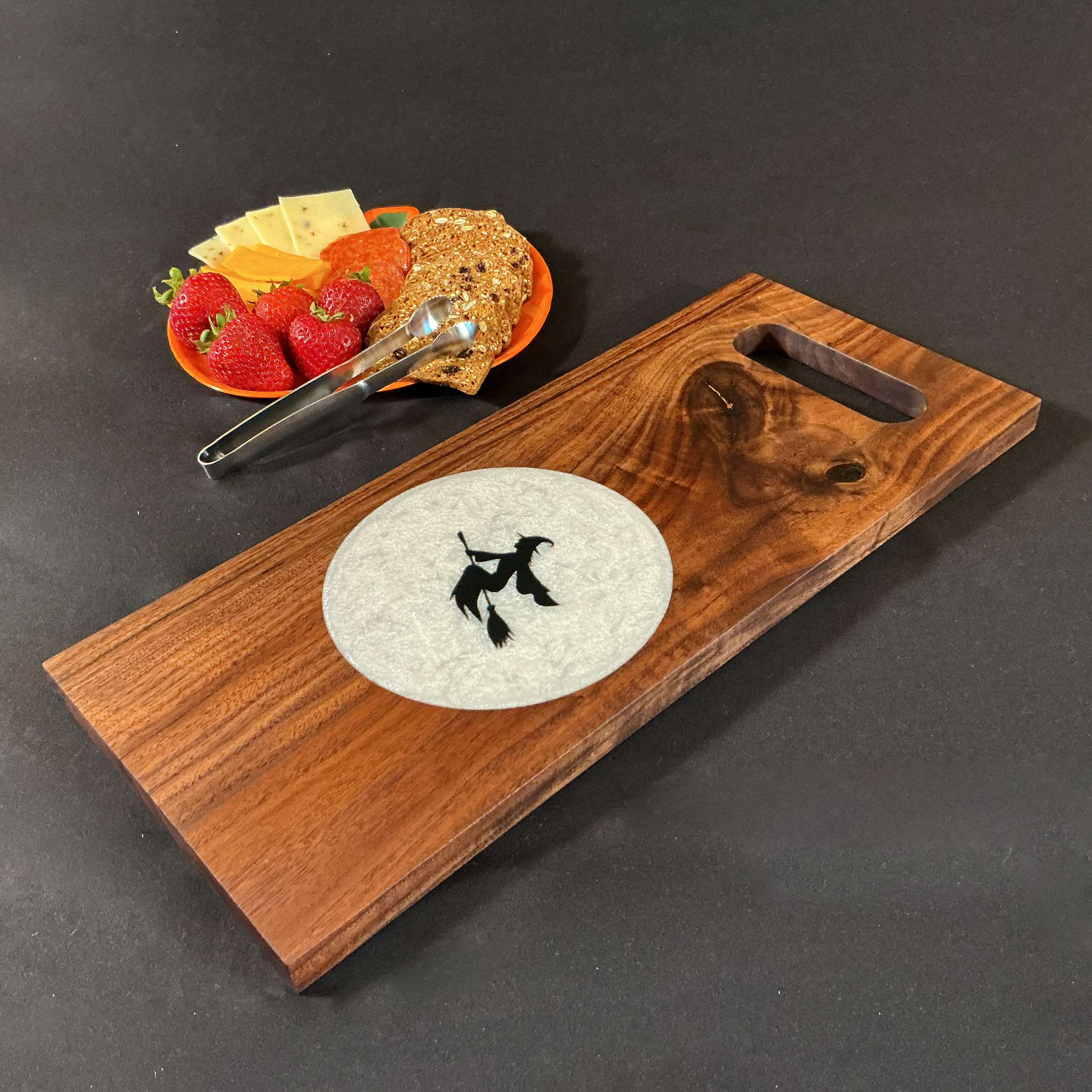 Witch silhouette on a full moon featuring walnut.