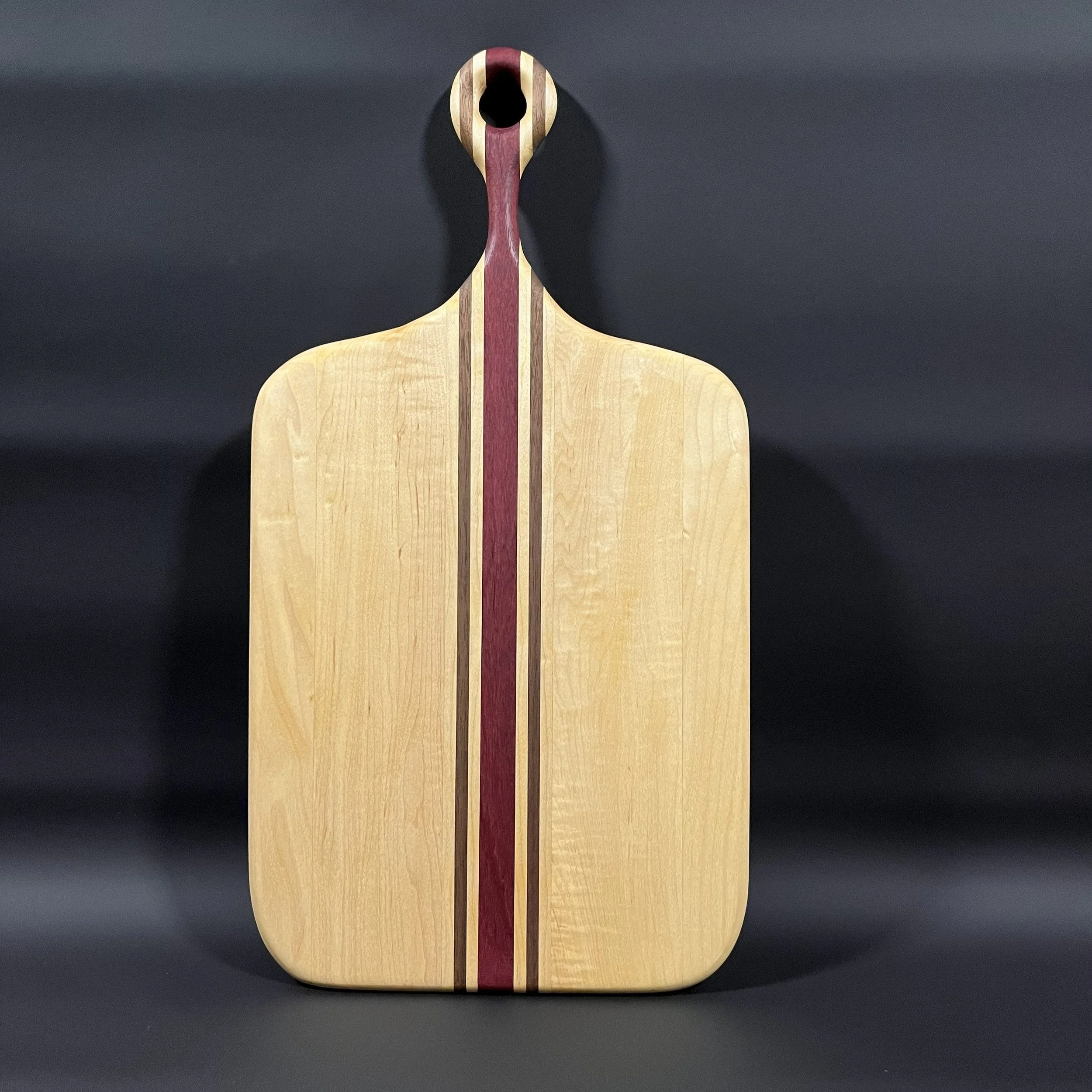 Maple paddle board with purple heart and walnut accent strips.