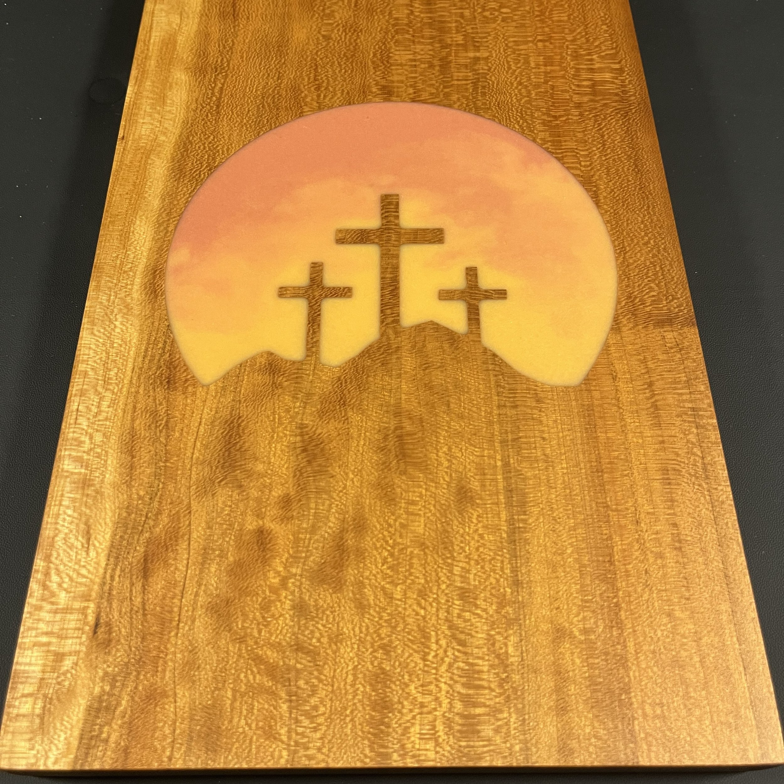 Calvary on warm cherry wood.