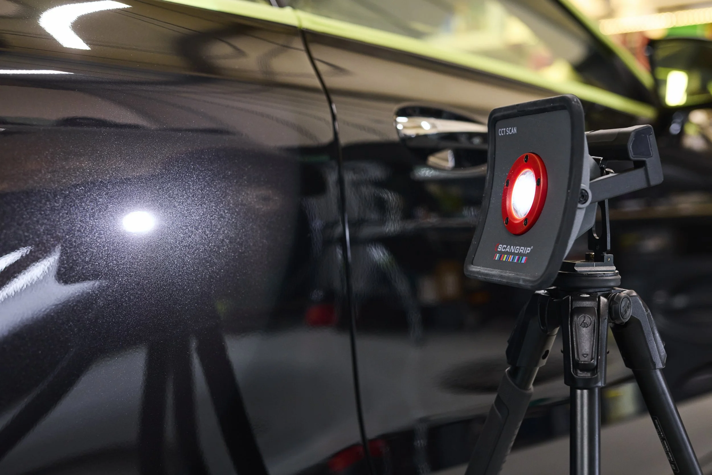 Paint inspection lighting setup revealing surface defects during car detailing process