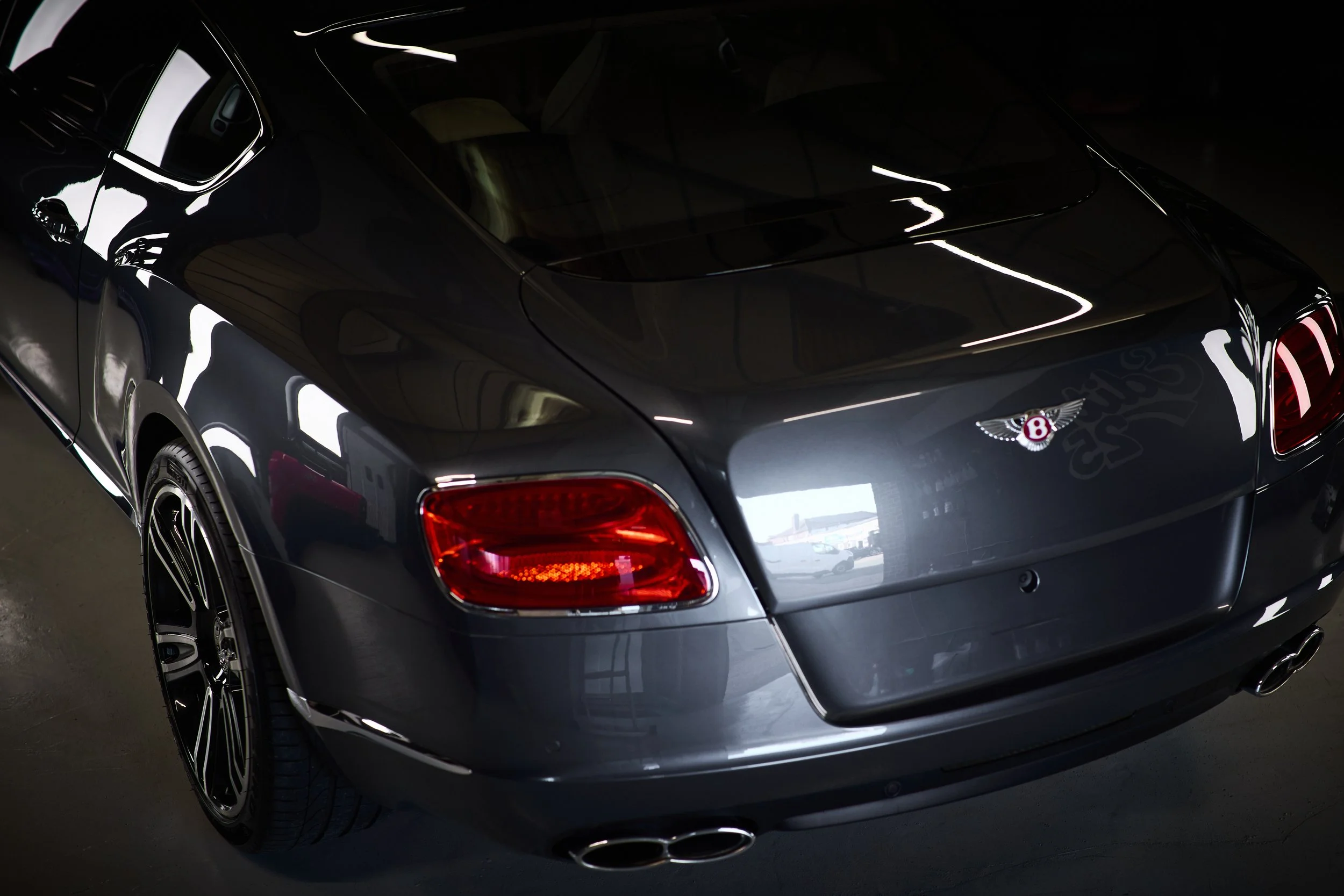 Bentley rear detail under controlled lighting showing paint refinement work at Edit 25 Detailing