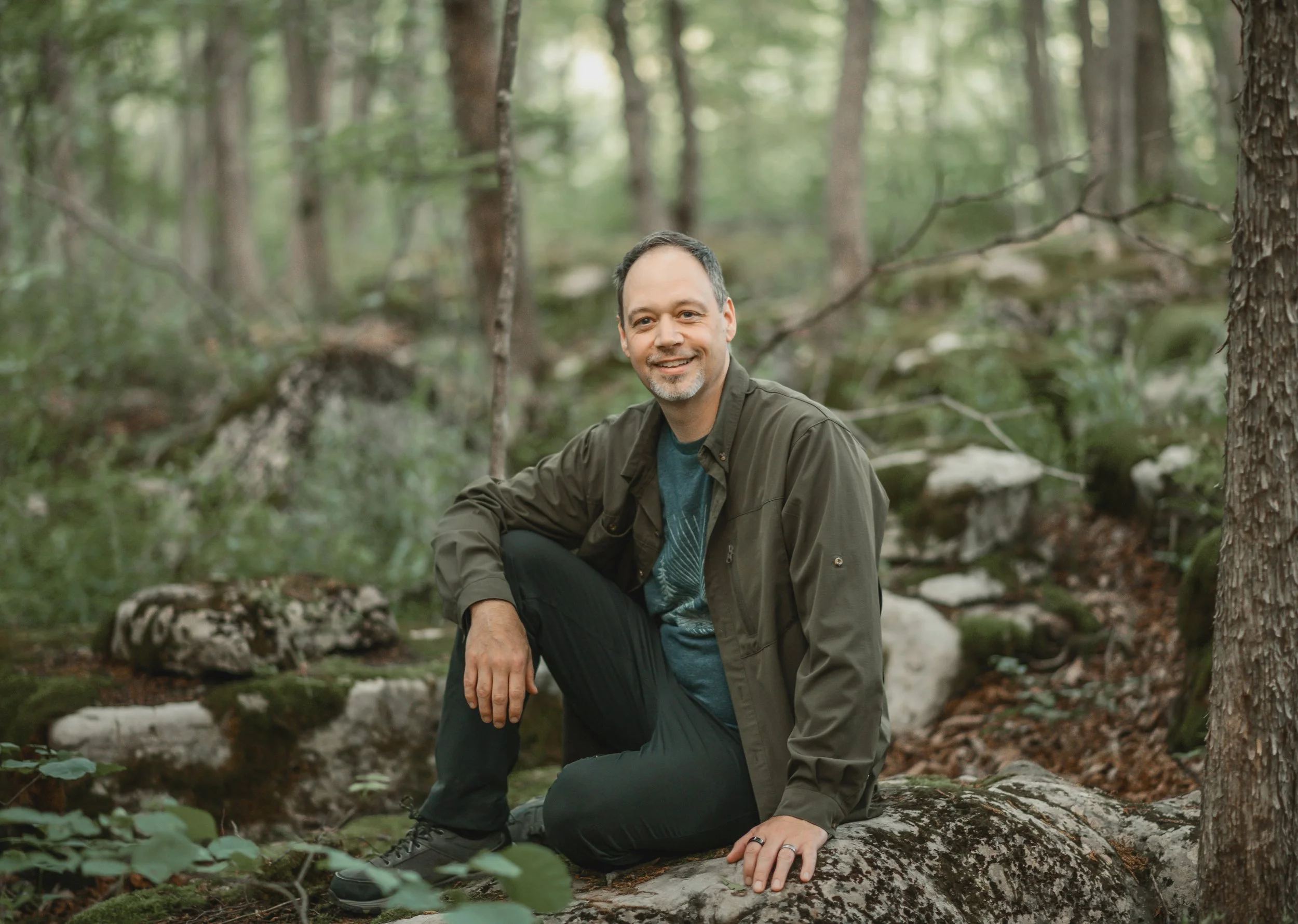 Portrait of Jeff Gillespie the somatic wellness practitioner sitting in the forest