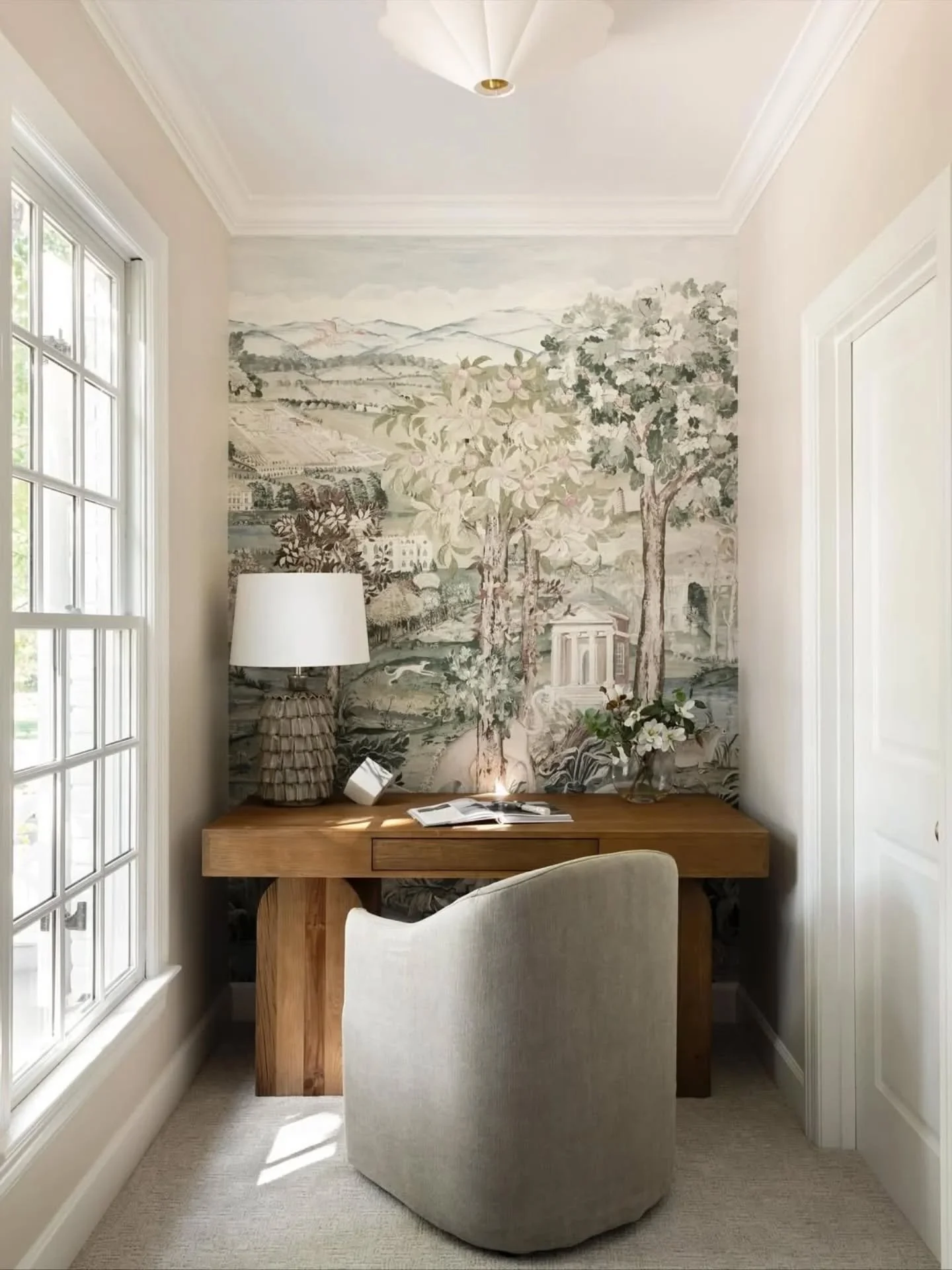 Proof that small spaces can have big views. 🌿 

I love how "Arcadian Thames" brings a breath of fresh air to this quiet nook, providing a fantastical vista to get lost in between tasks.

A mural wallpaper really can make a small room feel 