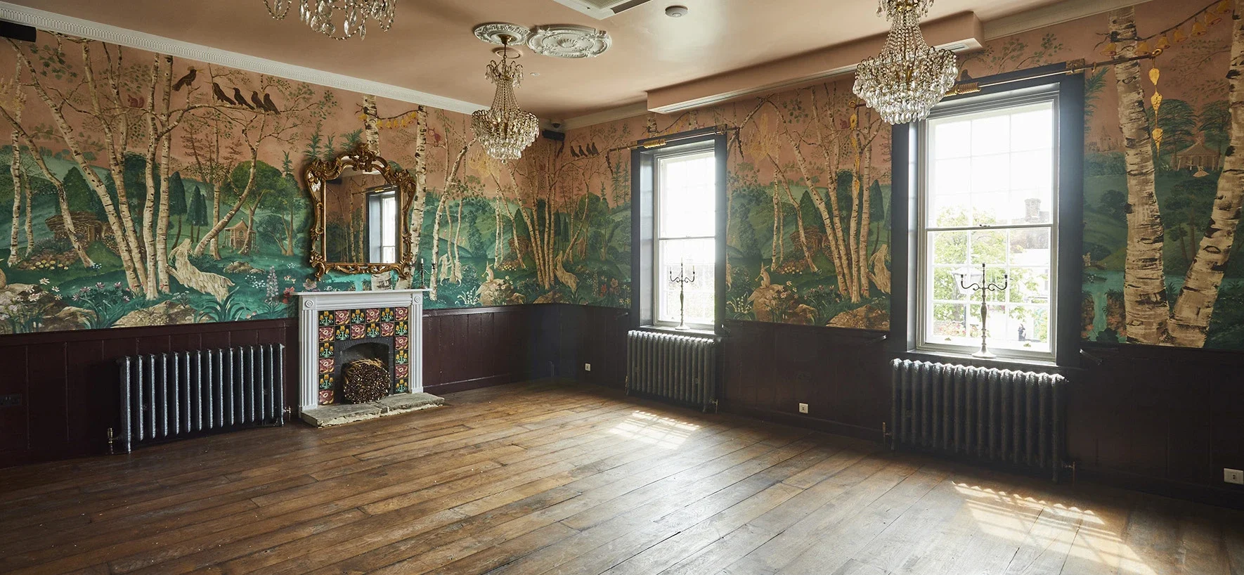 The Big Room at The Bell in Ticehurst, East Sussex, showing the bespoke scenic wallpaper by Melissa White, 2020. Room is shown empty with gleaming wooden floorboards just after work is complete.