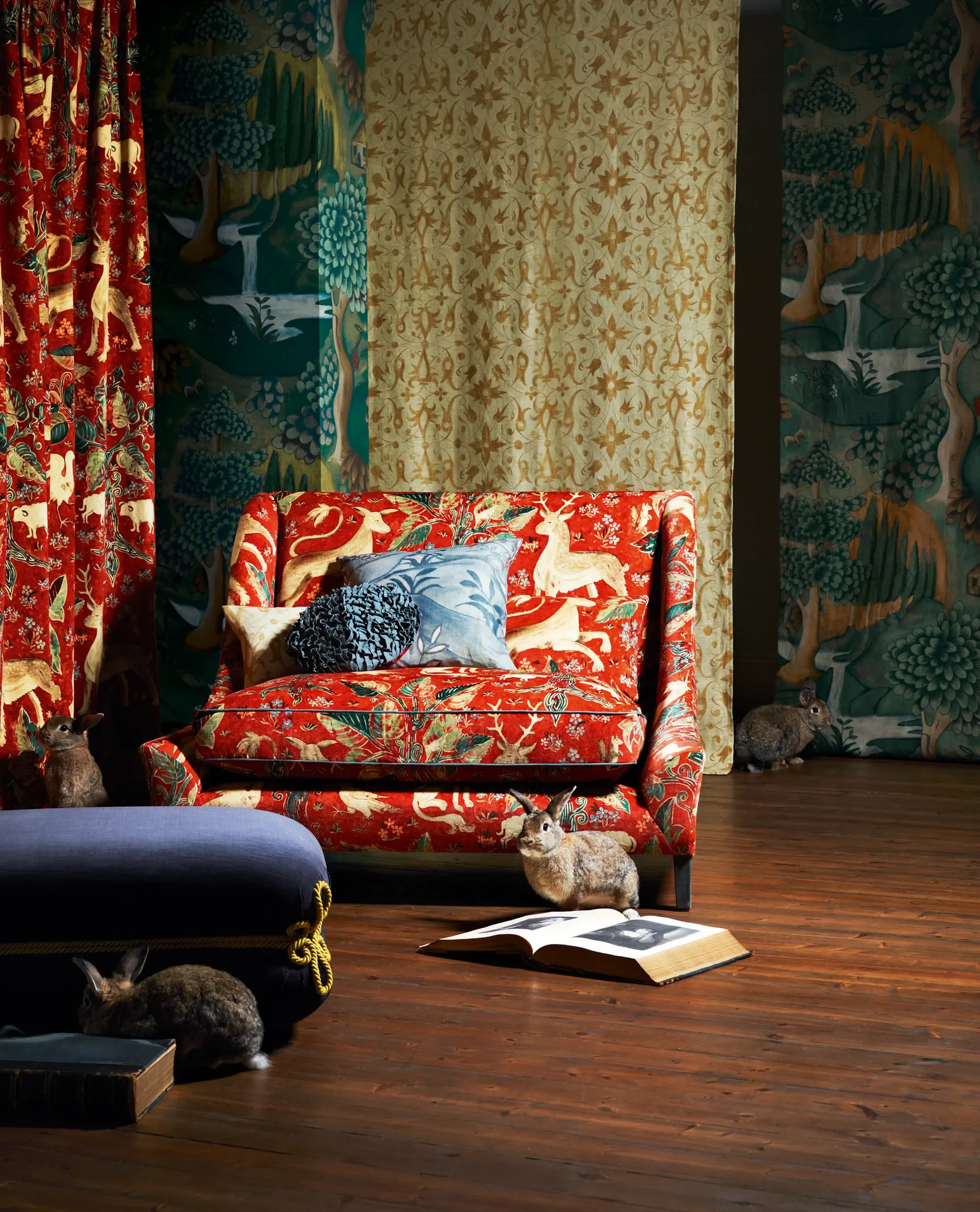 Interior scene with a red velvet sofa upholstered in Melissa White's red Arden fabric for Zoffany.