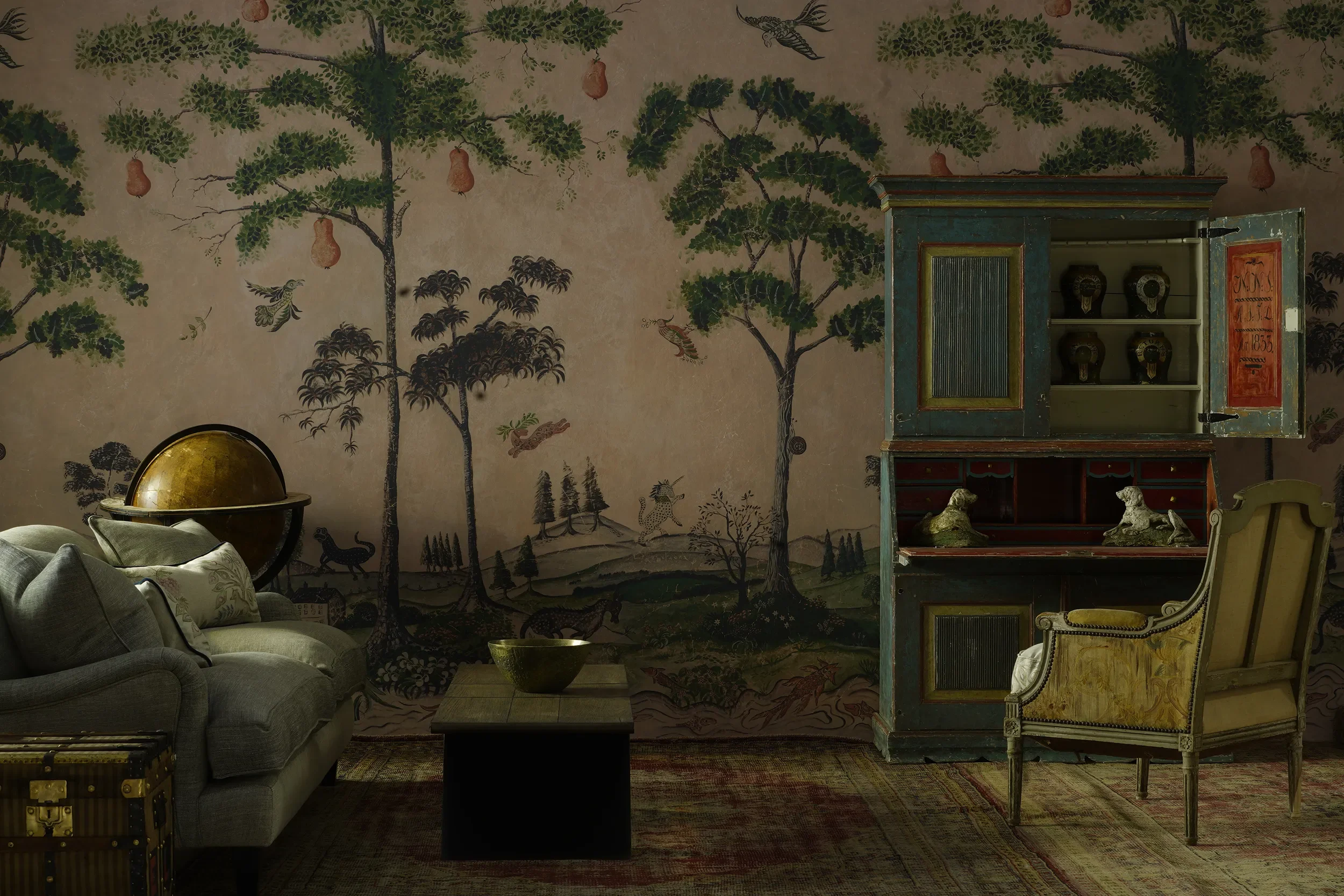 Melissa White's Mythical Land wallpaper (Kit Kemp/Andrew Martin) pictured in a room with antique and vintage furniture.