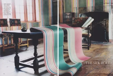 Split image showing a dining room on the left with a table and chairs in a room with striped curtains and on the right, a similar room with fabric bolts in various colors, including teal, pink, and cream, with a similar striped pattern.