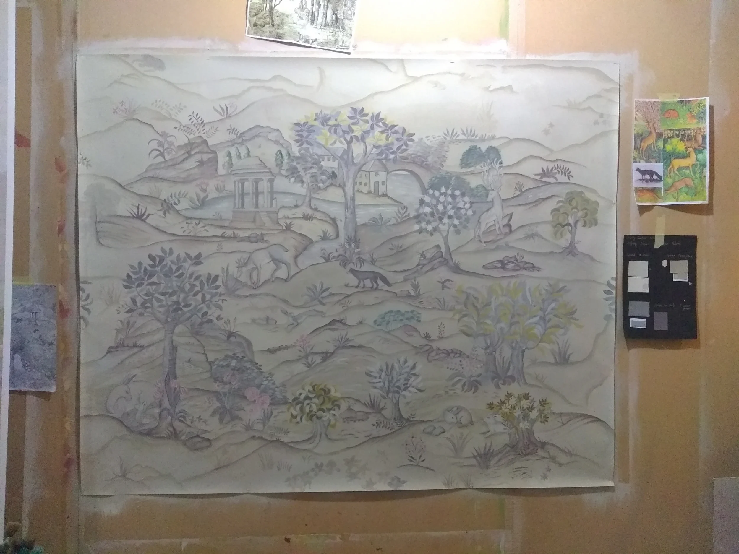 A large gray-scale landscape painting featuring mountains, trees, buildings, and a river, with some wildlife and plants visible in the foreground.
