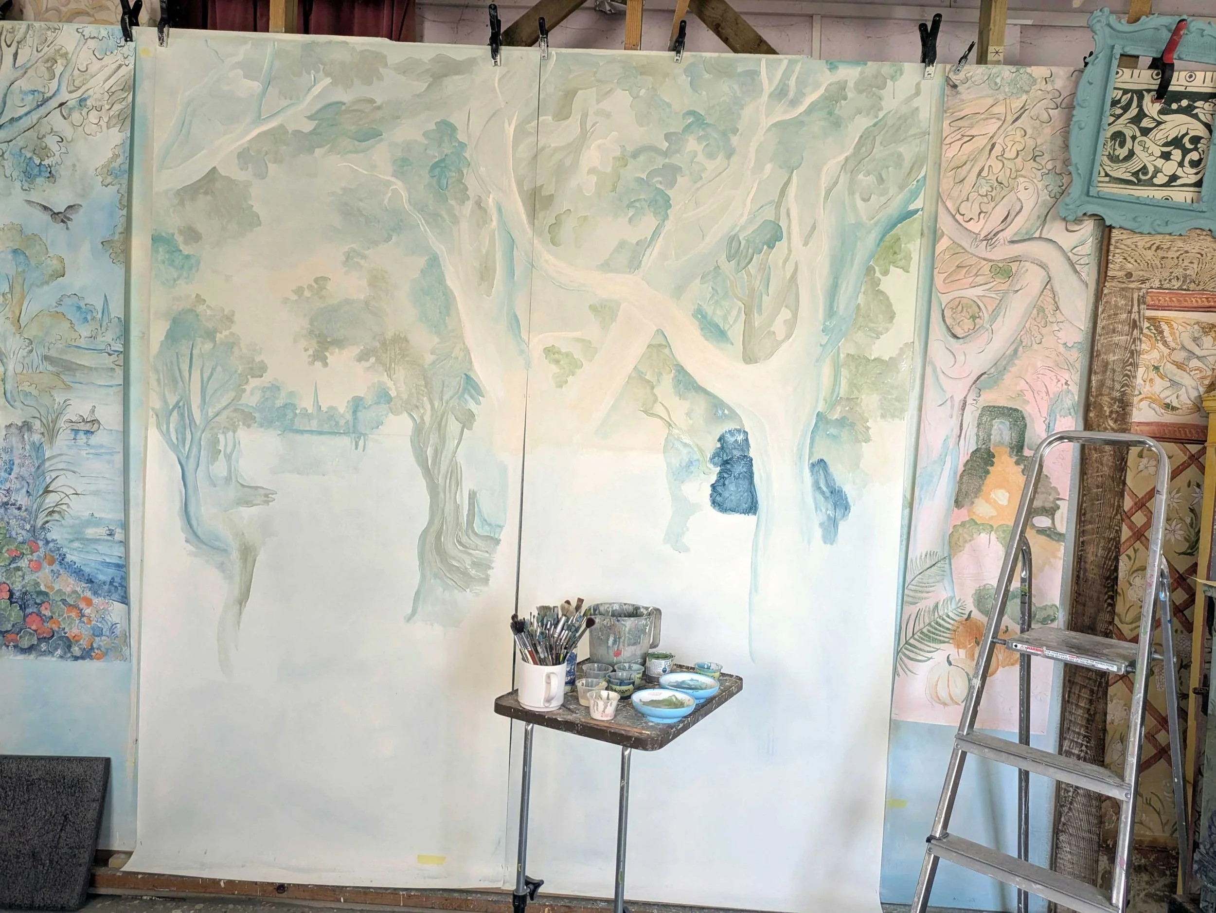 Work in progress of the Glimpses of Thyme mural showing the initial watery blue and green underpainting washes.