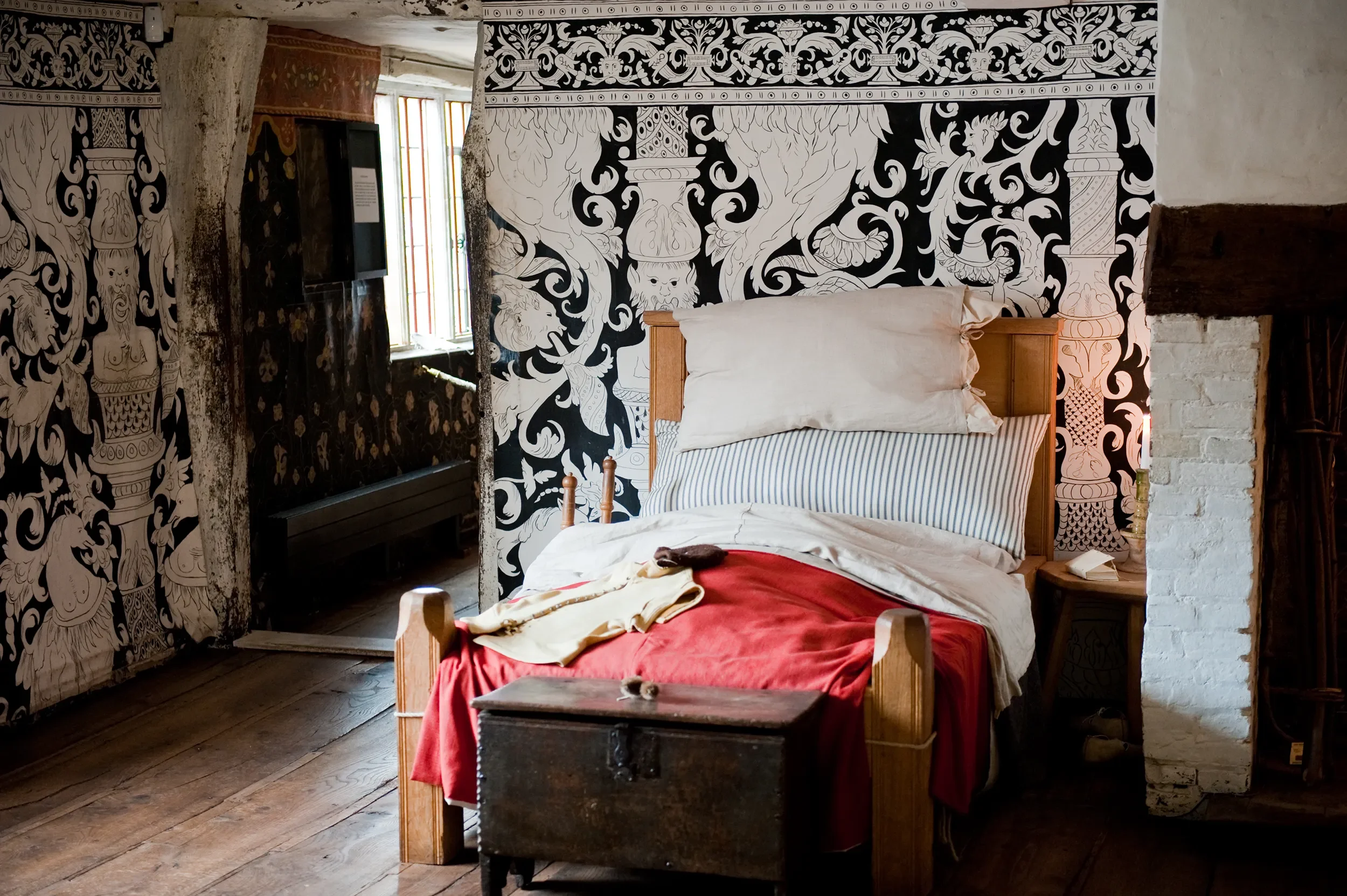 Melissa White's cloths for Shakespeare's Birthplace Museum are photographed in situ with a large Tudor bed.