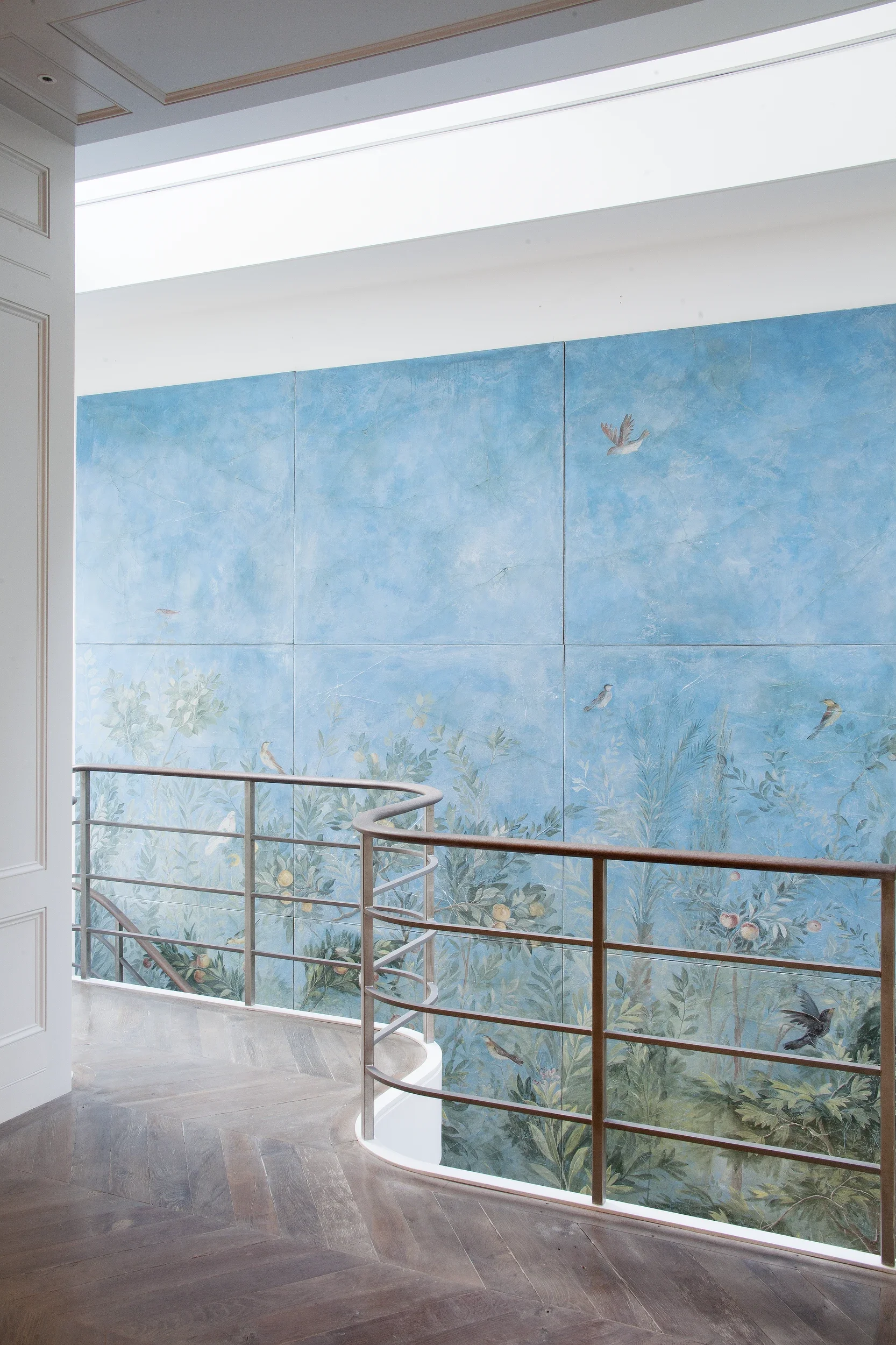 Melissa White's Villa of Livia fresco secco panels seen from the top landing in their domestic setting in Holland Park.