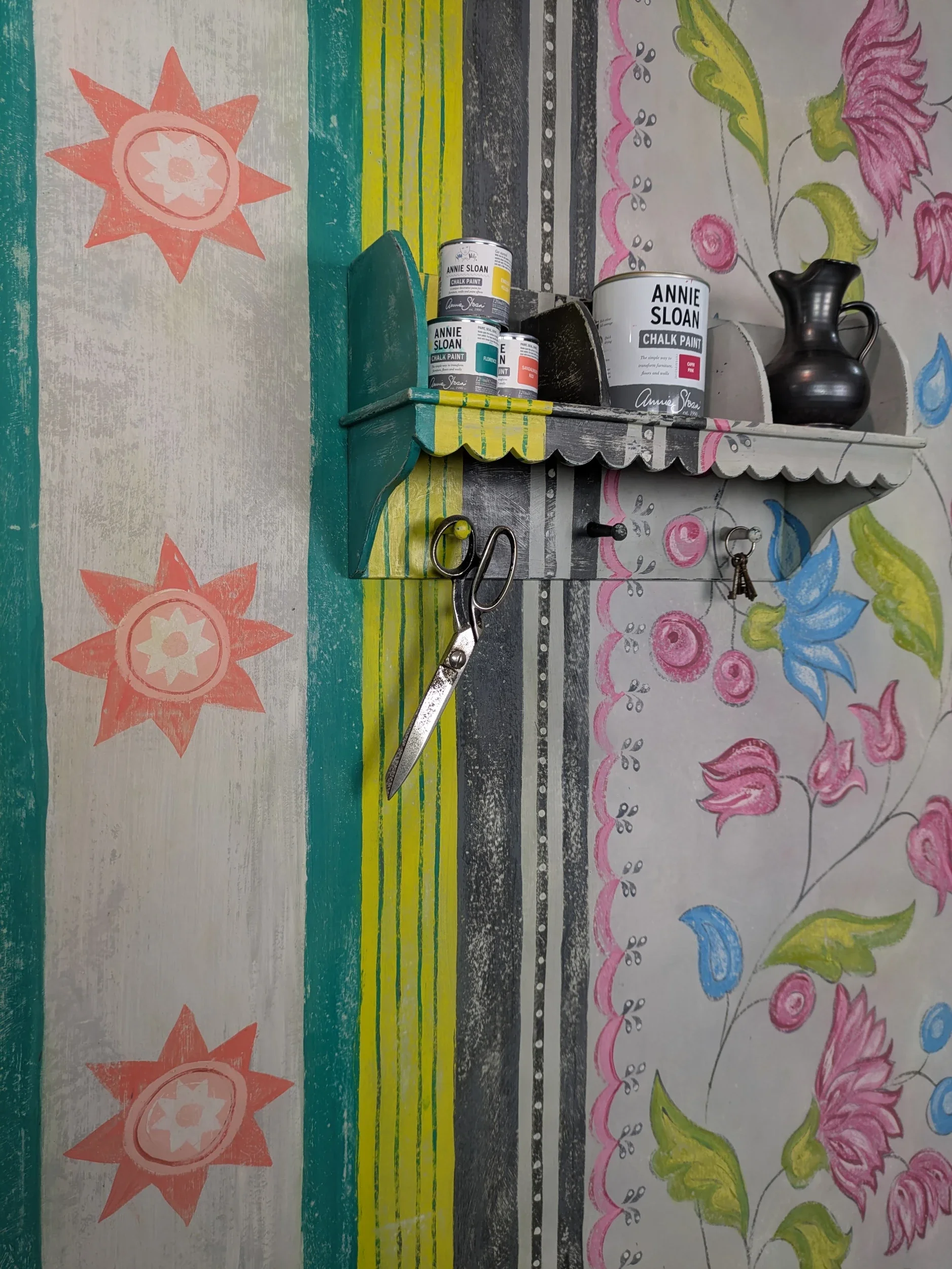 Melissa White's Chalkhouse wallpainting is shown with a shelf showing off Annie Sloan chalk paints. Painted while Melissa was Annie Sloan Painter in Residence.