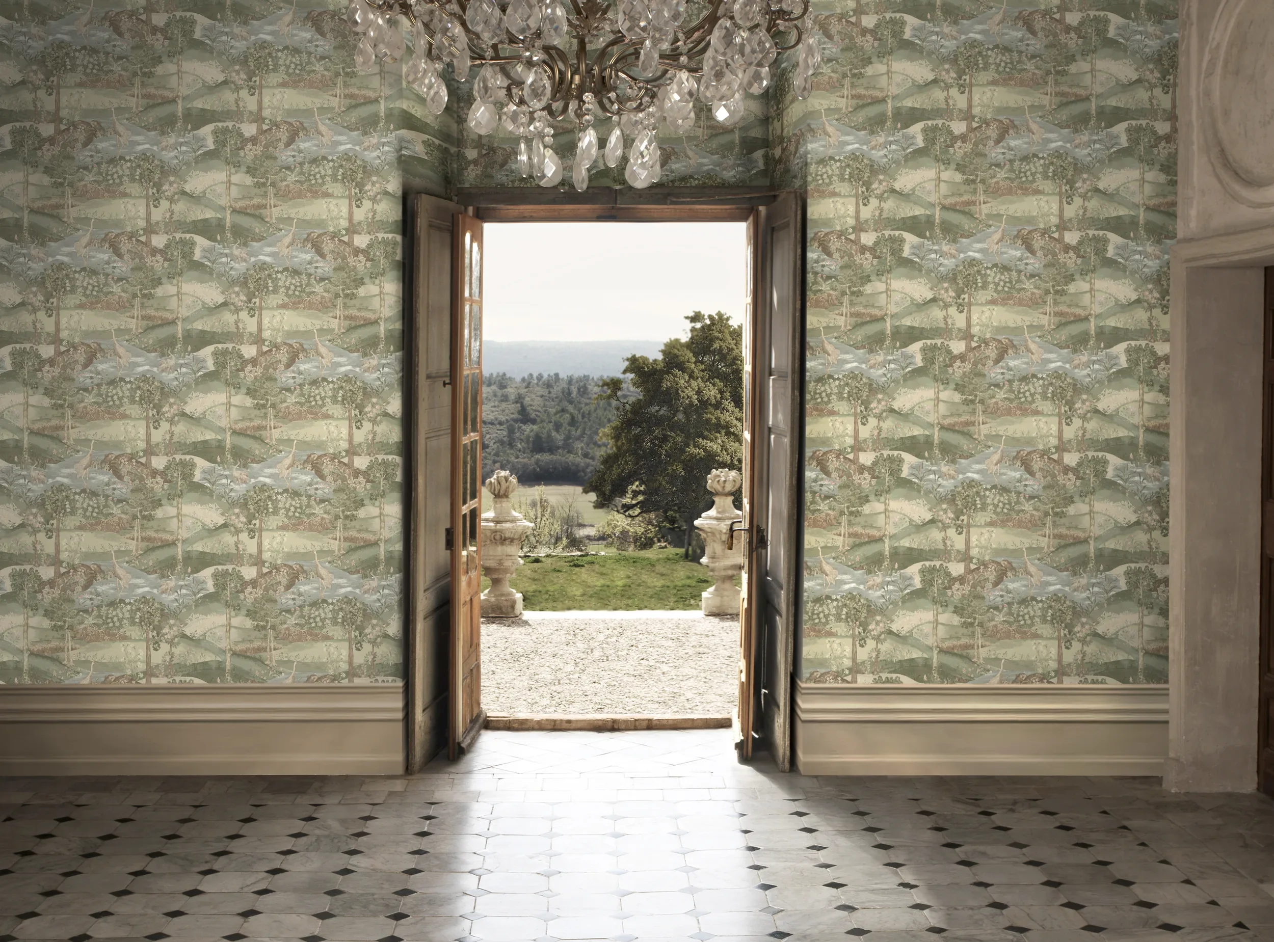 Open double doors leading outside to trees and landscape. The room has patterned wallpaper with nature scene, a chandelier hanging from the ceiling, and black-and-white tiled floor.