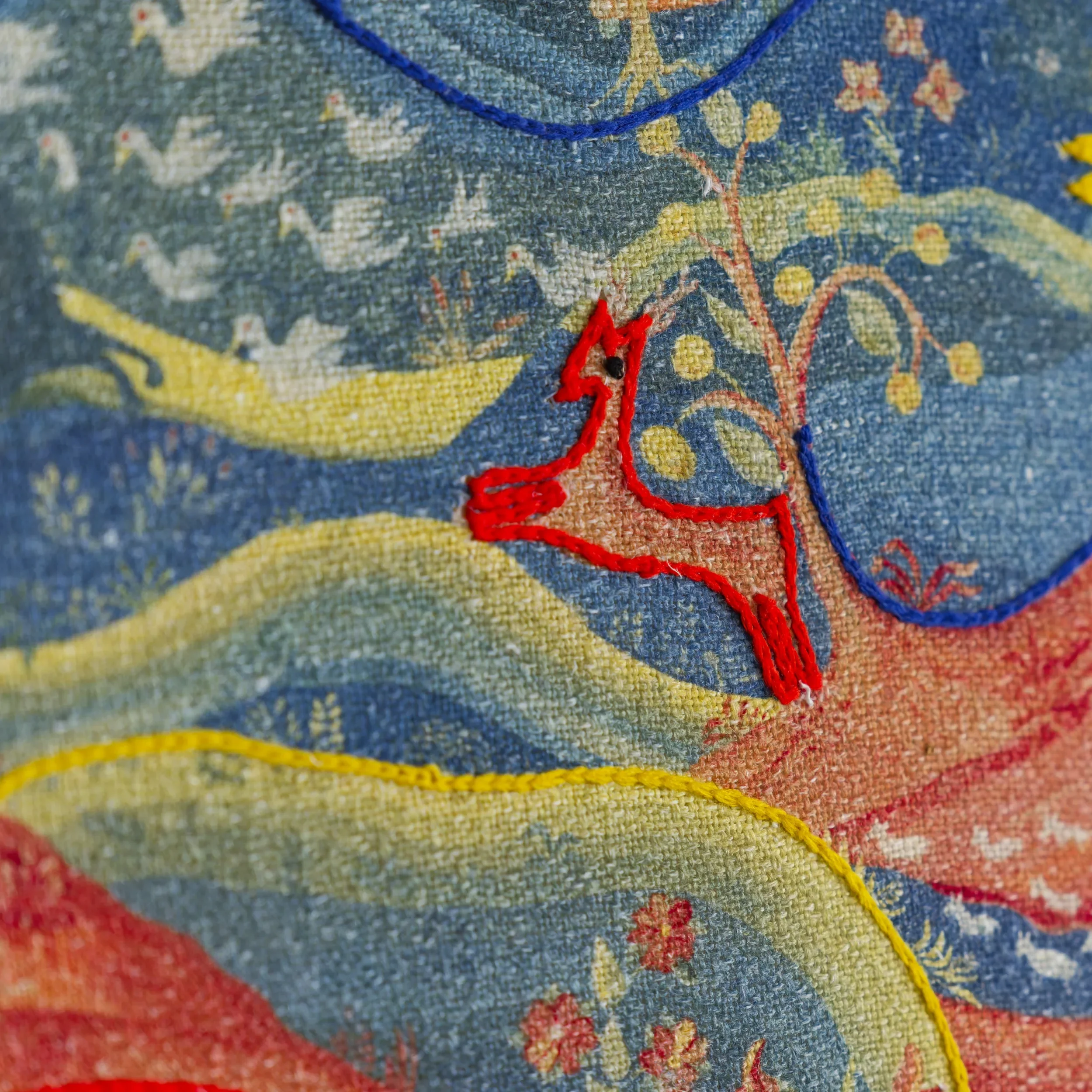 Close-up of embroidered Meadow Multi cushion by Melissa White in collaboration with Kit Kemp for Andrew Martin.